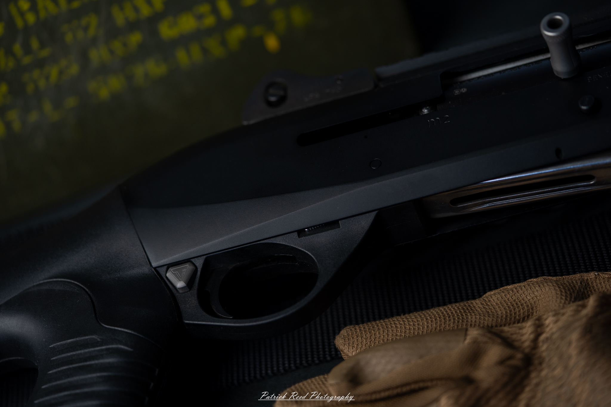 "A close-up shot of a Benelli M2 Tactical shotgun, highlighting its sleek lines and tactical features. The image captures details such as the textured grip, the magazine tube, and the overall build quality, showcasing the shotgun's reliability and performance in a tactical setting."