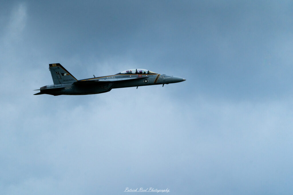 "The F-16 Fighting Falcon, a highly versatile multirole fighter jet, is depicted in a dynamic flight pose against a clear blue sky. This aircraft features a sleek and aerodynamic design with a distinctive nose and a single-engine layout. The F-16 is adorned with a vibrant paint scheme, showcasing its military insignia and squadron markings. Its advanced avionics and weapon systems make it capable of performing a wide range of missions, from air superiority to ground attack. The image captures the F-16's agility and power, highlighting its status as one of the most iconic fighter jets in modern aviation."