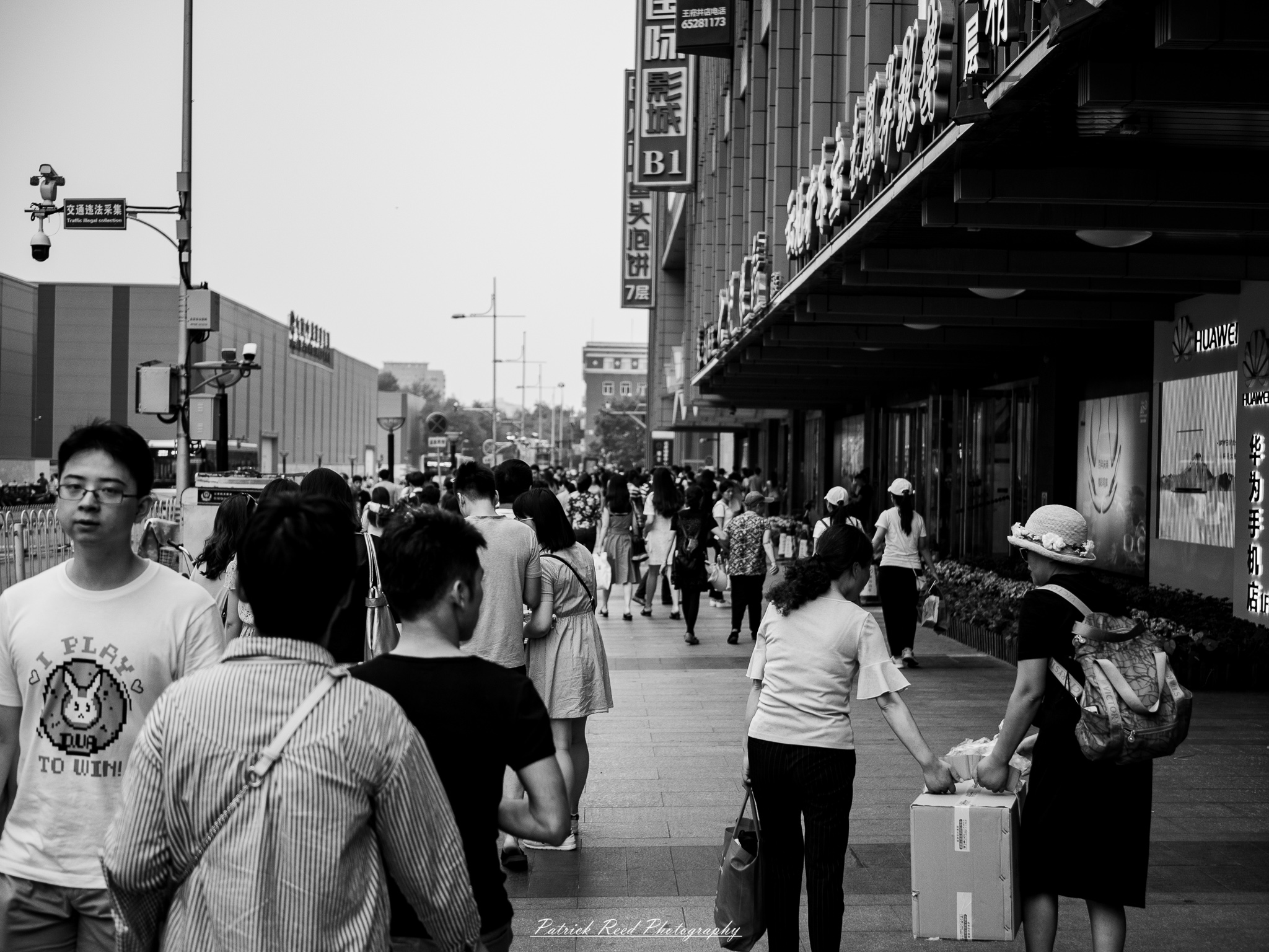 A series of noir-style street photography scenes set in Beijing, China, at night. The rain-slicked alleys and streets reflect the dim glow of neon signs from small shops, tea houses, and street vendors. Silhouettes of people walking under umbrellas or riding bicycles disappear into the misty night. Traditional hutong architecture with tiled roofs and red lanterns contrasts with modern high-rise buildings and glowing billboards in the distance. The interplay of deep shadows and warm artificial lights creates a cinematic, moody atmosphere, capturing the essence of noir storytelling in the heart of the city.