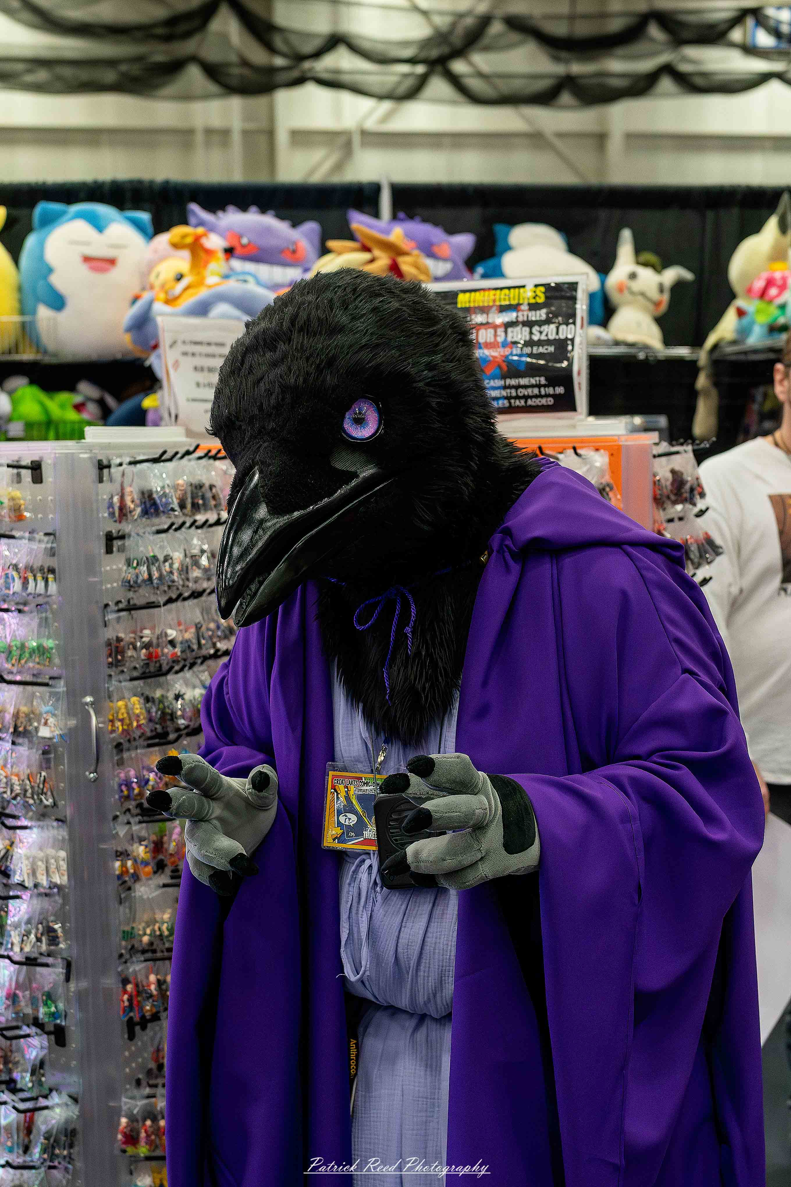 Great Lakes Comic Con 11 A group of cosplayers posing on stage at the Great Lakes Comic Con cosplay contest, dressed as various characters from comics, anime, and video games. The audience watches from below as the participants show off their detailed costumes under bright stage lights.