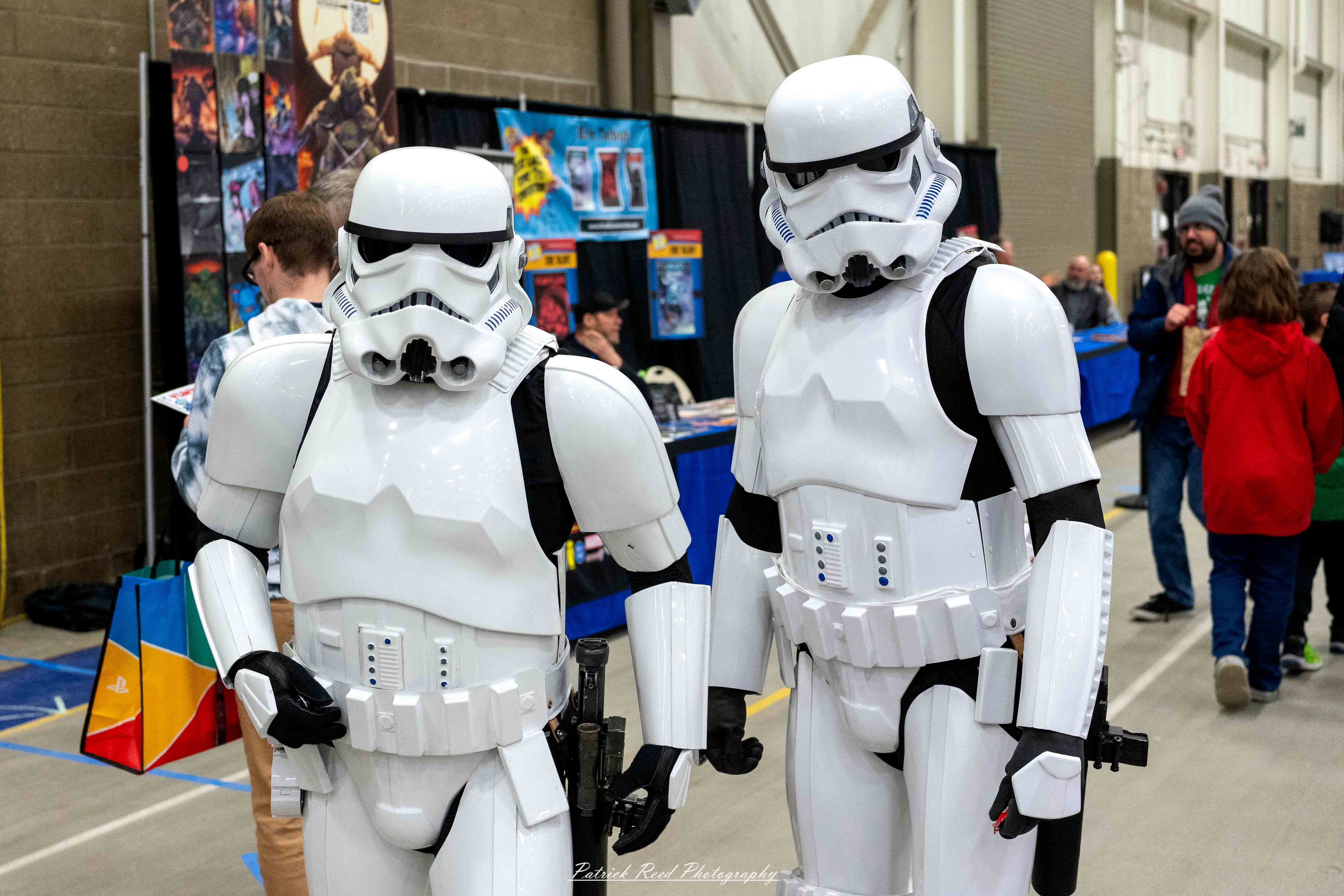 Great Lakes Comic Con 3 Two cosplayers dressed as Stormtroopers from Star Wars stand side by side at the Great Lakes Comic Con cosplay contest. They wear screen-accurate white armor with black detailing and iconic helmets, each holding a blaster rifle.