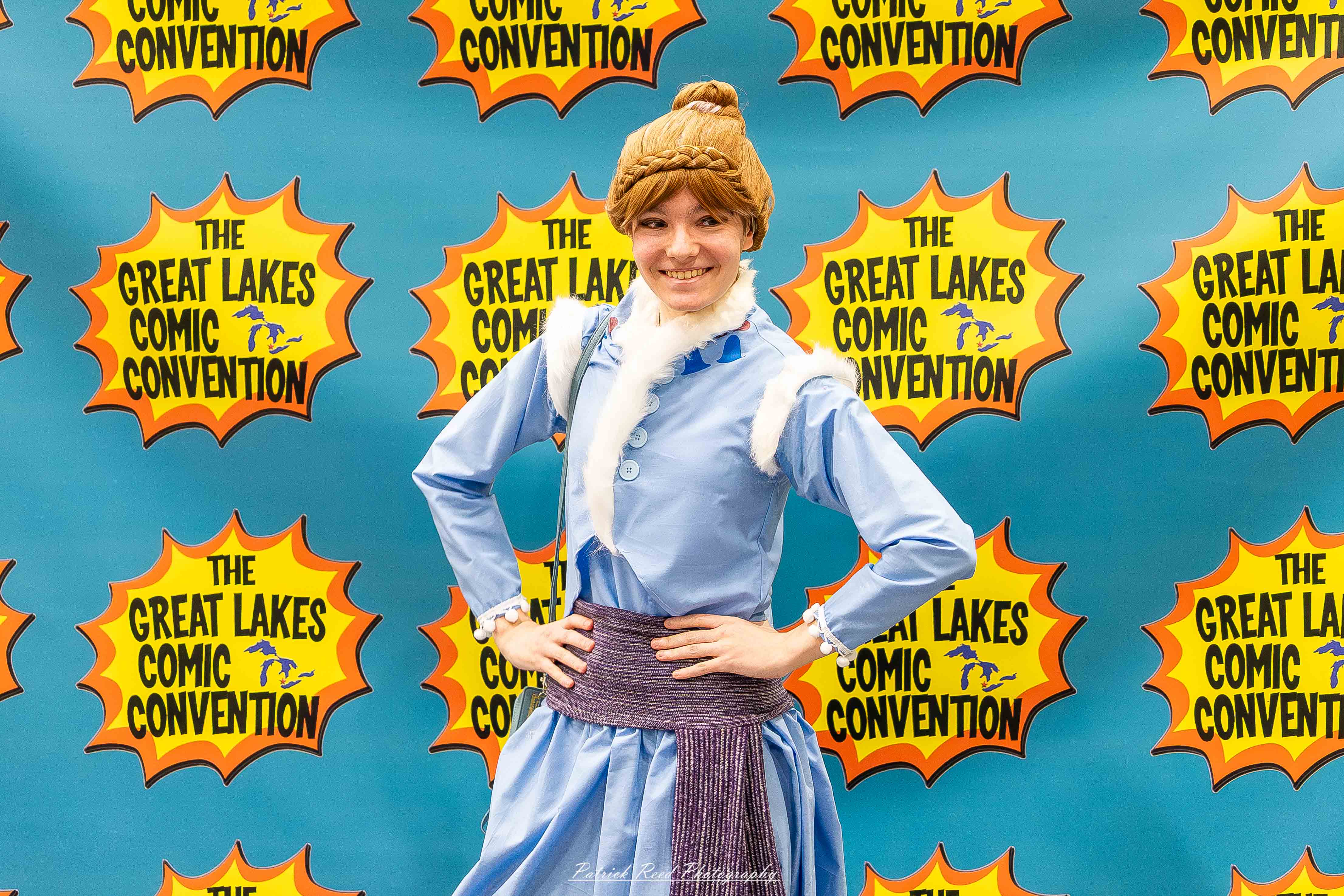 Great Lakes Comic Con 30 Alt text: A group of cosplayers posing on stage at the Great Lakes Comic Con cosplay contest, dressed as various characters from comics, anime, and video games. The audience watches from below as the participants show off their detailed costumes under bright stage lights.