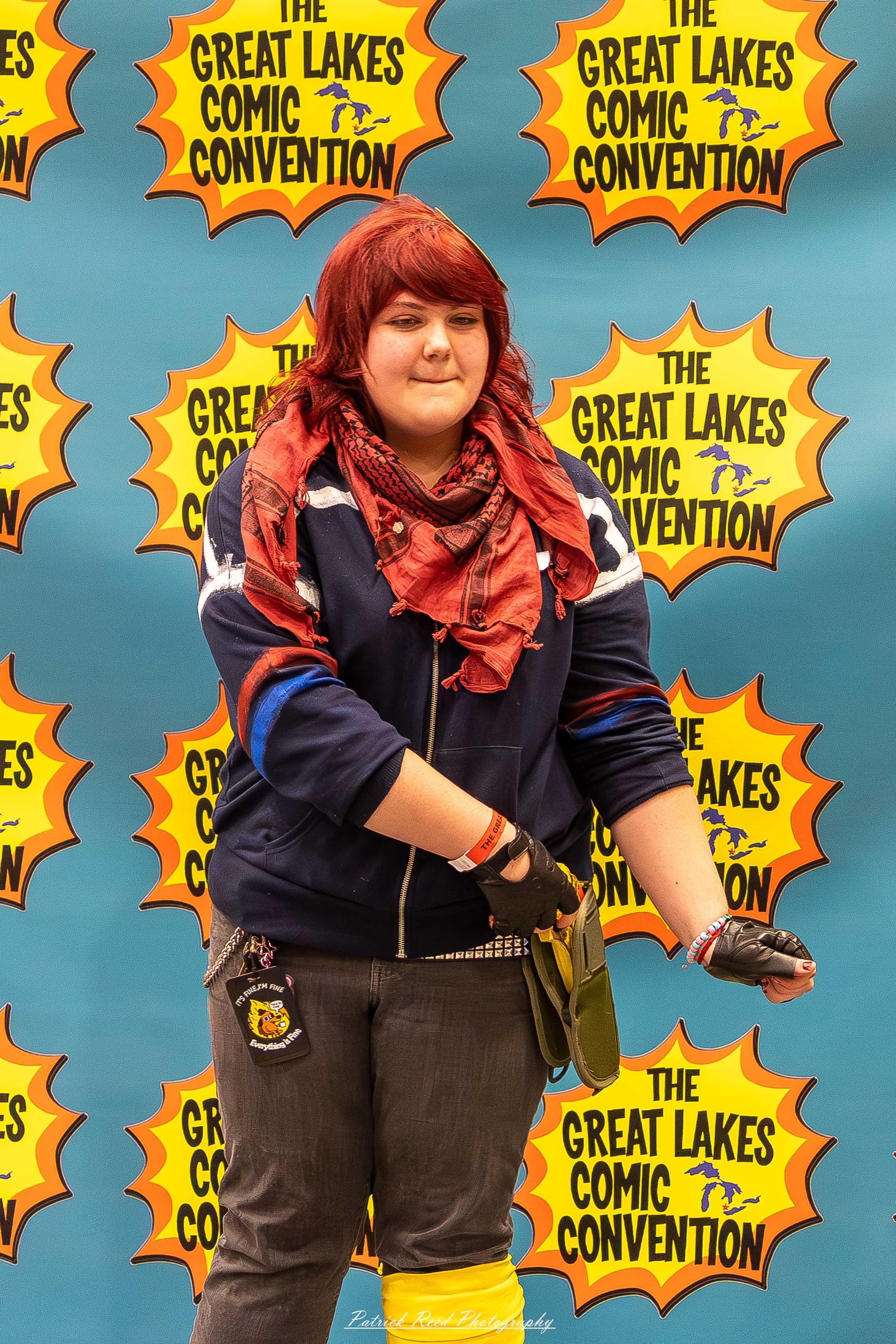 Great Lakes Comic Con 34 Alt text: A group of cosplayers posing on stage at the Great Lakes Comic Con cosplay contest, dressed as various characters from comics, anime, and video games. The audience watches from below as the participants show off their detailed costumes under bright stage lights.