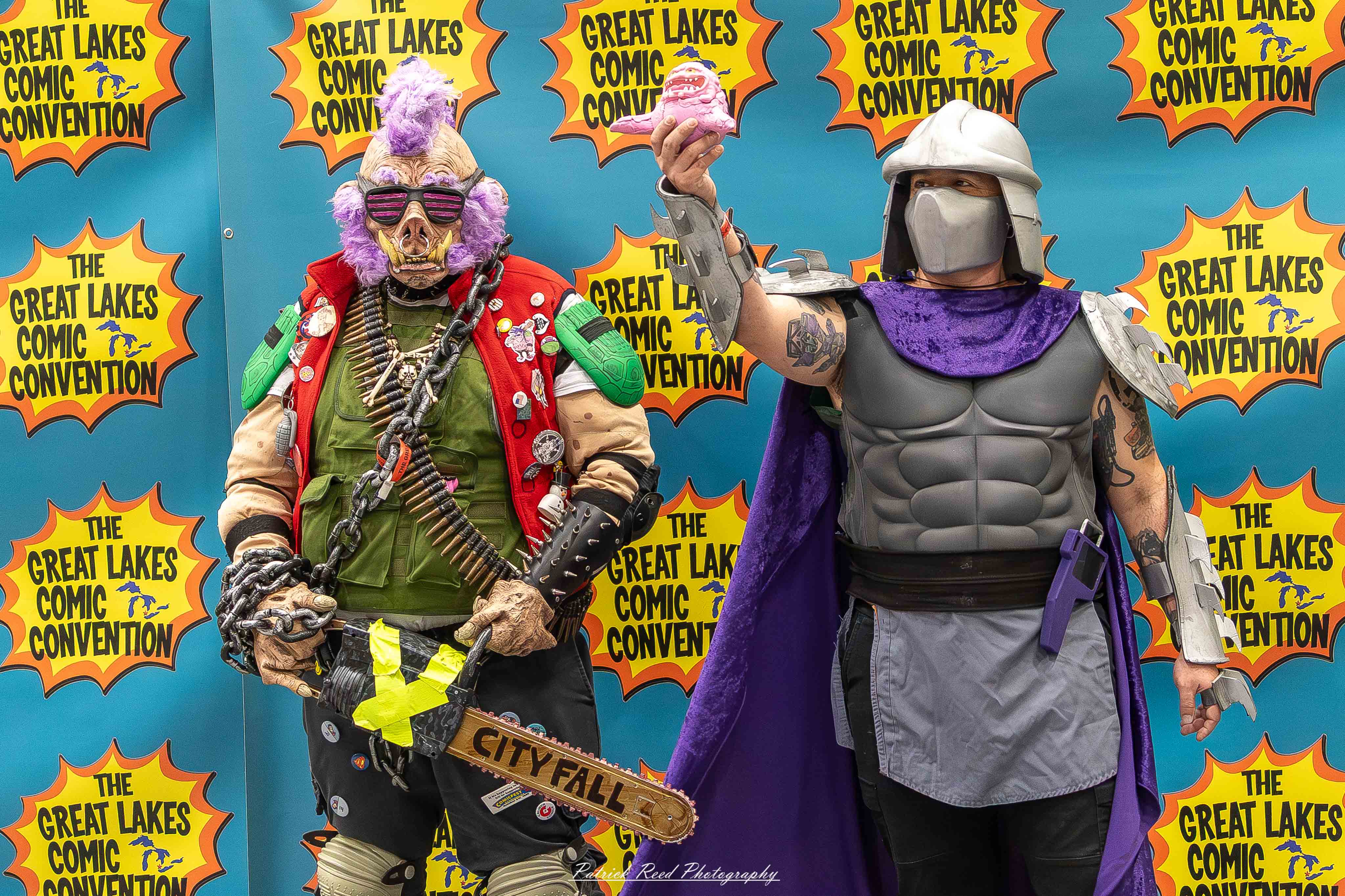 Great Lakes Comic Con 41 Alt text: A group of cosplayers posing on stage at the Great Lakes Comic Con cosplay contest, dressed as various characters from comics, anime, and video games. The audience watches from below as the participants show off their detailed costumes under bright stage lights.