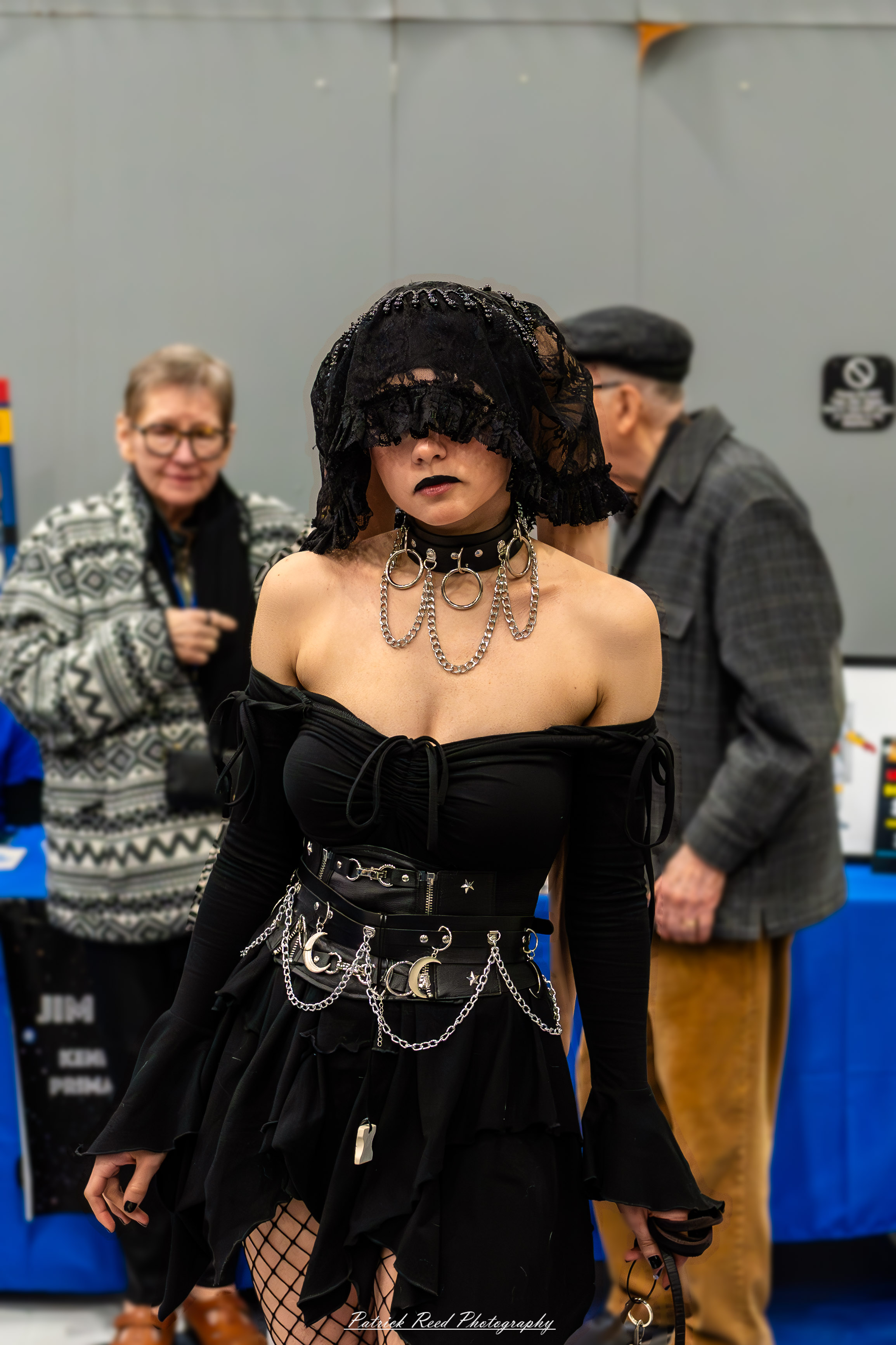 Great Lakes Comic Con 5 A cosplayer dressed as a Twi'lek poses at the Great Lakes Comic Con cosplay contest. They wear black lace attire paired with a detailed headpiece featuring long lekku, capturing the iconic Star Wars alien look.