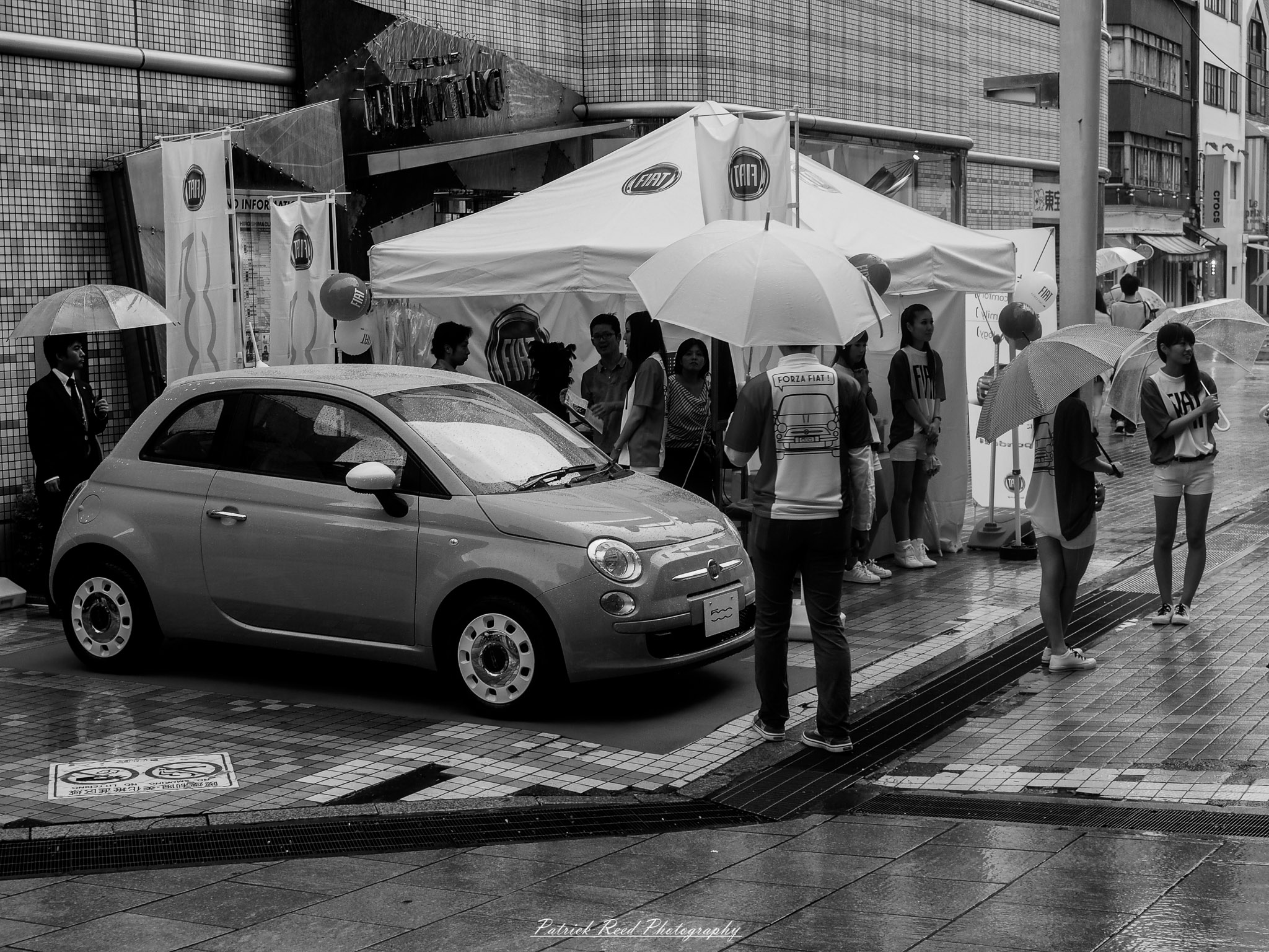 A series of noir-style street photography scenes set in Hiroshima, Japan, at night. The rain-slicked streets and narrow alleys reflect the soft glow of neon signs from izakayas, small shops, and vending machines. Silhouettes of people walking under umbrellas move through the misty atmosphere, their shadows stretching across the pavement. Traditional Japanese architecture, such as wooden facades and noren curtains, blends with modern urban elements like glowing billboards and bicycles parked along dimly lit sidewalks. The moody lighting, deep contrasts, and quiet yet cinematic ambiance evoke a sense of mystery and nostalgia, capturing the noir aesthetic in a contemporary Japanese cityscape.