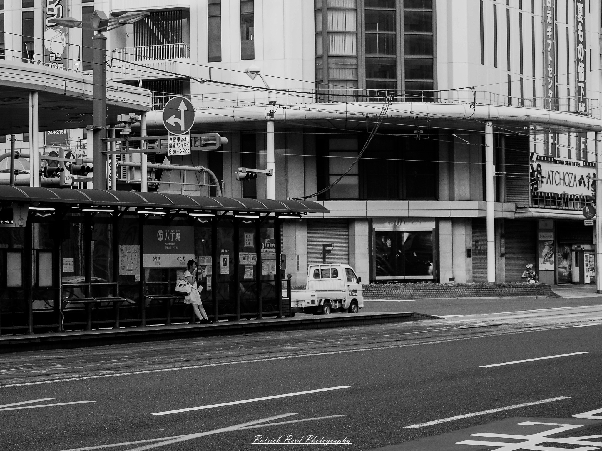 A series of noir-style street photography scenes set in Hiroshima, Japan, at night. The rain-slicked streets and narrow alleys reflect the soft glow of neon signs from izakayas, small shops, and vending machines. Silhouettes of people walking under umbrellas move through the misty atmosphere, their shadows stretching across the pavement. Traditional Japanese architecture, such as wooden facades and noren curtains, blends with modern urban elements like glowing billboards and bicycles parked along dimly lit sidewalks. The moody lighting, deep contrasts, and quiet yet cinematic ambiance evoke a sense of mystery and nostalgia, capturing the noir aesthetic in a contemporary Japanese cityscape.