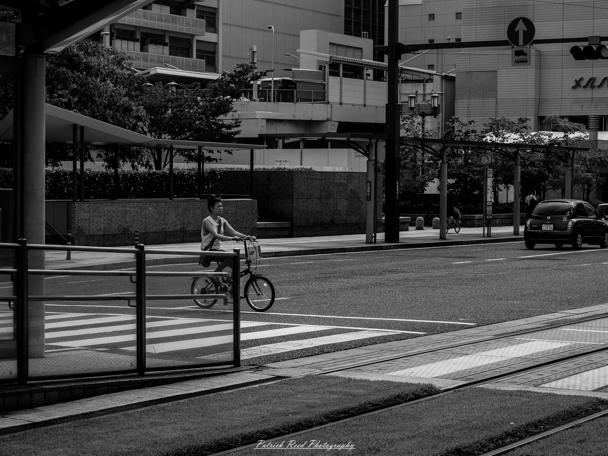 A series of noir-style street photography scenes set in Hiroshima, Japan, at night. The rain-slicked streets and narrow alleys reflect the soft glow of neon signs from izakayas, small shops, and vending machines. Silhouettes of people walking under umbrellas move through the misty atmosphere, their shadows stretching across the pavement. Traditional Japanese architecture, such as wooden facades and noren curtains, blends with modern urban elements like glowing billboards and bicycles parked along dimly lit sidewalks. The moody lighting, deep contrasts, and quiet yet cinematic ambiance evoke a sense of mystery and nostalgia, capturing the noir aesthetic in a contemporary Japanese cityscape.
