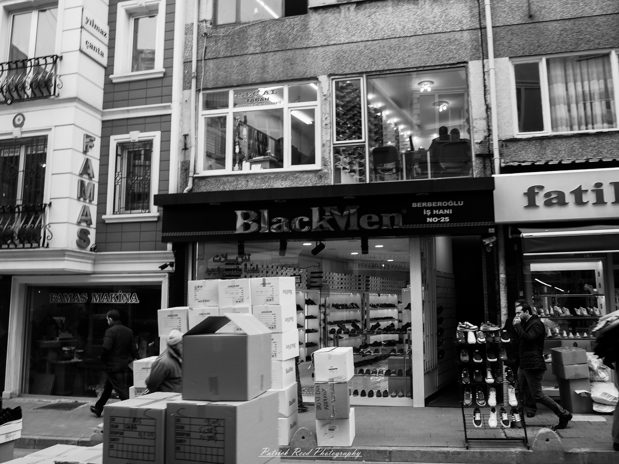 Turkey 13 A series of noir-style street photography scenes set in Istanbul, Turkey, at night. The dimly lit streets and narrow alleys are wet from rain, reflecting the warm glow of streetlights and neon signs. Silhouettes of people walking, some carrying umbrellas, move through the misty atmosphere. The scenes highlight a blend of historical Ottoman architecture, such as arched doorways and intricate stone facades, with modern urban elements like cafes, storefronts, and graffiti. The Bosphorus skyline and glimpses of minarets in the distance add to the cinematic, mysterious ambiance. The overall mood is evocative and steeped in noir storytelling.