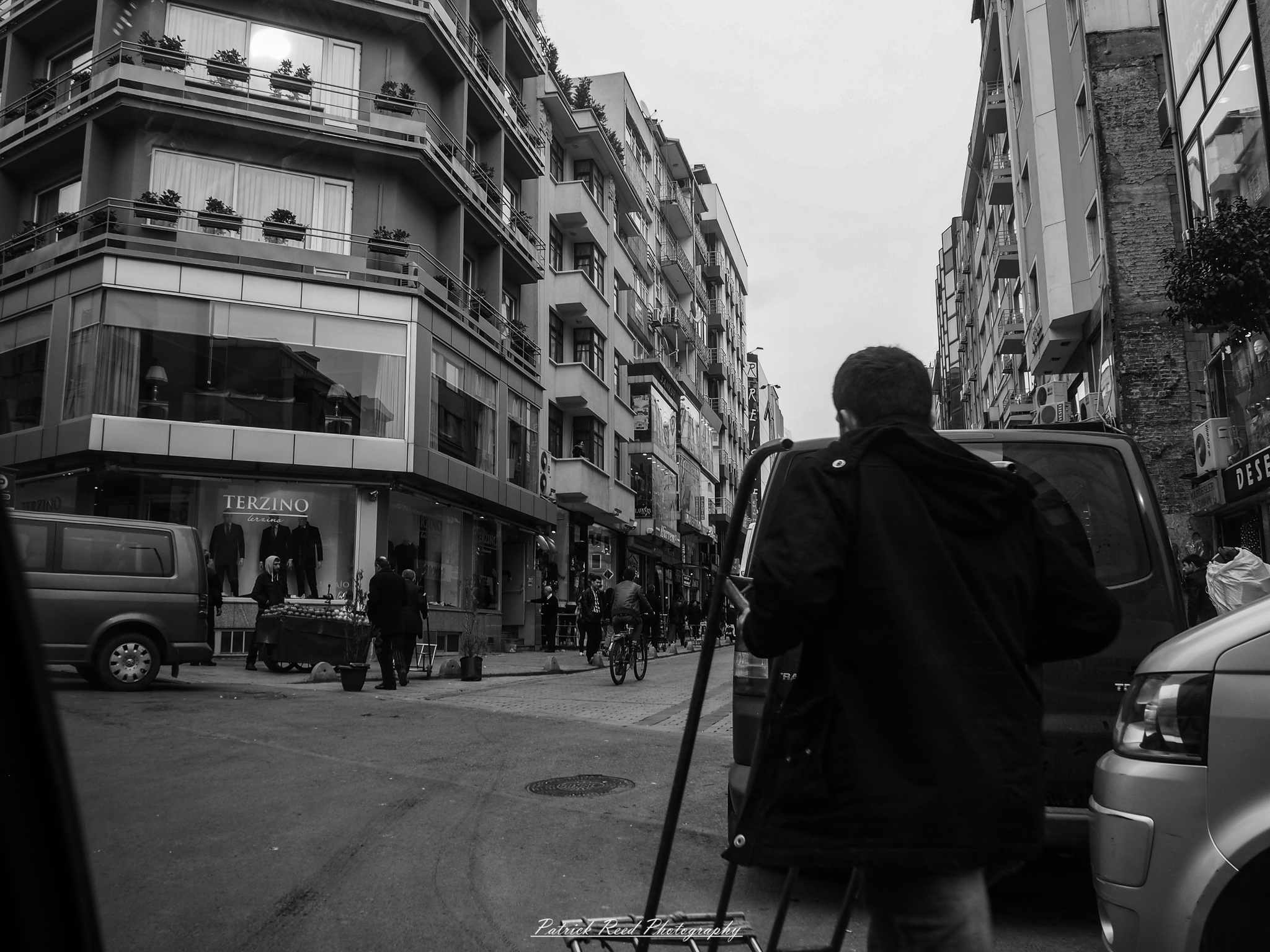 A series of noir-style street photography scenes set in Istanbul, Turkey, at night. The dimly lit streets and narrow alleys are wet from rain, reflecting the warm glow of streetlights and neon signs. Silhouettes of people walking, some carrying umbrellas, move through the misty atmosphere. The scenes highlight a blend of historical Ottoman architecture, such as arched doorways and intricate stone facades, with modern urban elements like cafes, storefronts, and graffiti. The Bosphorus skyline and glimpses of minarets in the distance add to the cinematic, mysterious ambiance. The overall mood is evocative and steeped in noir storytelling.