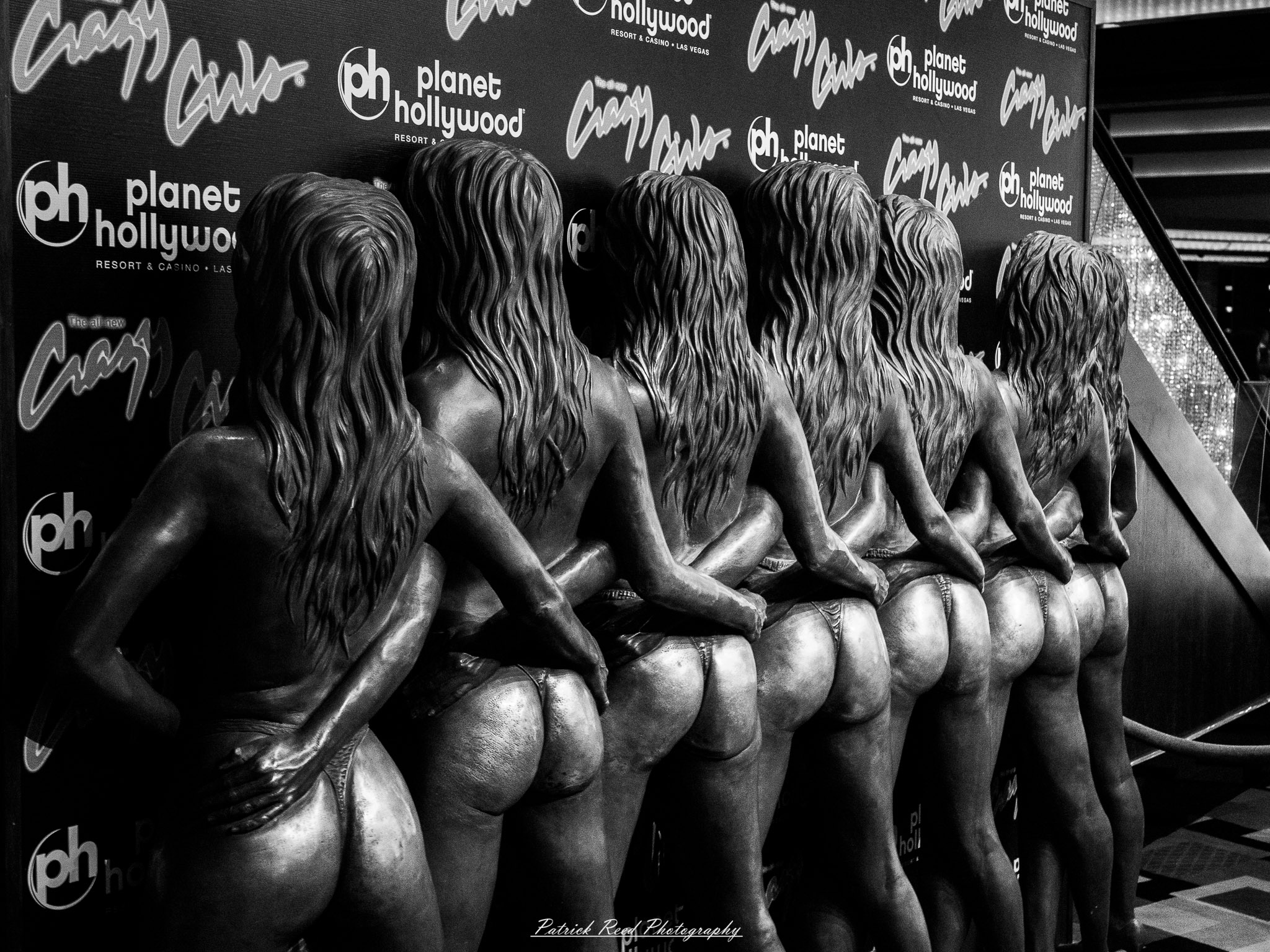 Vegas 15 A series of noir-style street photography scenes set in Las Vegas, Nevada, at night. The rain-slicked streets reflect the vibrant glow of neon signs from casinos, motels, and diners. Silhouettes of people walking under umbrellas or leaning against lampposts add a sense of mystery and intrigue. The scenes capture a mix of classic Vegas landmarks, vintage signage, and gritty back alleys with graffiti and scattered debris. The dramatic lighting emphasizes shadows and contrasts, creating a moody, cinematic ambiance that evokes the essence of noir storytelling in a bustling yet shadowy cityscape.