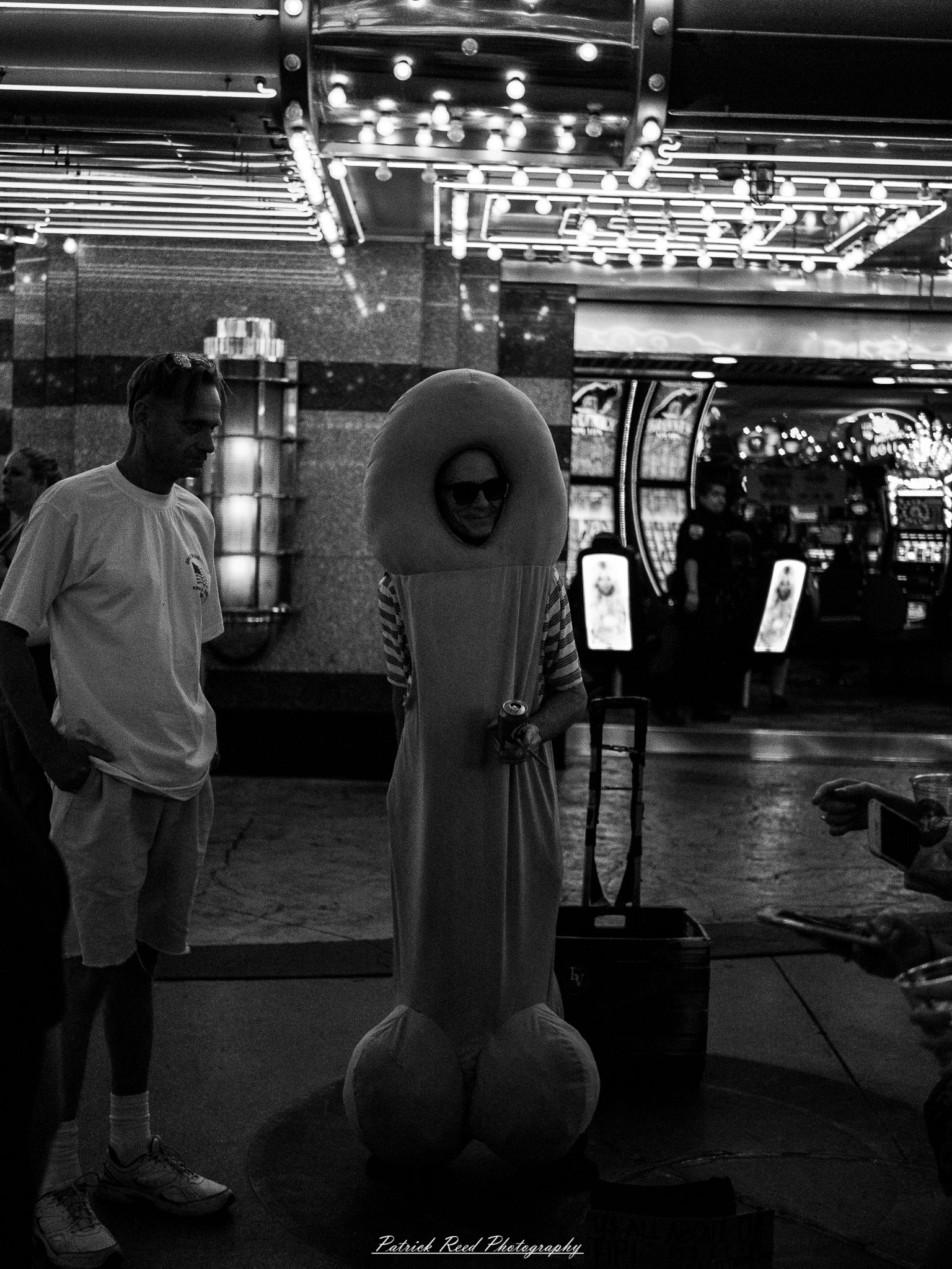 Vegas 21 A series of noir-style street photography scenes set in Las Vegas, Nevada, at night. The rain-slicked streets reflect the vibrant glow of neon signs from casinos, motels, and diners. Silhouettes of people walking under umbrellas or leaning against lampposts add a sense of mystery and intrigue. The scenes capture a mix of classic Vegas landmarks, vintage signage, and gritty back alleys with graffiti and scattered debris. The dramatic lighting emphasizes shadows and contrasts, creating a moody, cinematic ambiance that evokes the essence of noir storytelling in a bustling yet shadowy cityscape.