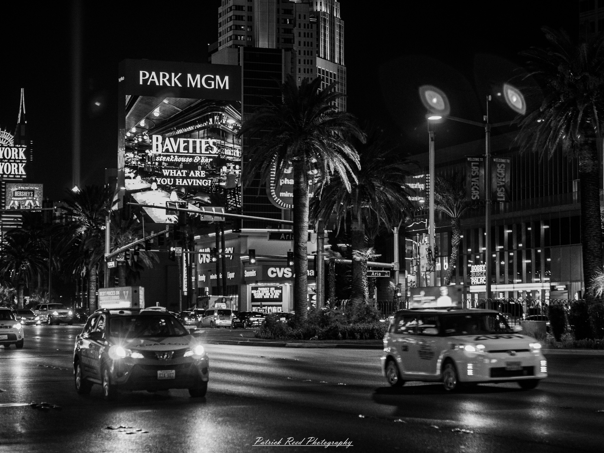 Vegas 36 A series of noir-style street photography scenes set in Las Vegas, Nevada, at night. The rain-slicked streets reflect the vibrant glow of neon signs from casinos, motels, and diners. Silhouettes of people walking under umbrellas or leaning against lampposts add a sense of mystery and intrigue. The scenes capture a mix of classic Vegas landmarks, vintage signage, and gritty back alleys with graffiti and scattered debris. The dramatic lighting emphasizes shadows and contrasts, creating a moody, cinematic ambiance that evokes the essence of noir storytelling in a bustling yet shadowy cityscape.