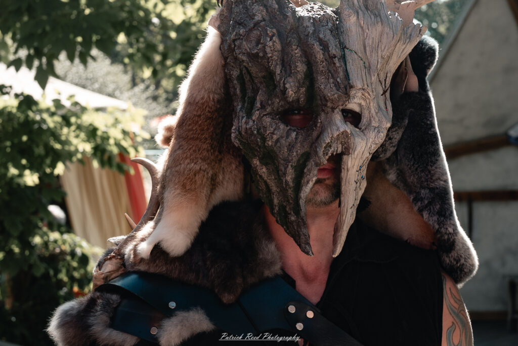 A costumed performer at the Michigan Renaissance Festival 2025, wearing traditional Renaissance attire during a live event in Holly, Michigan.