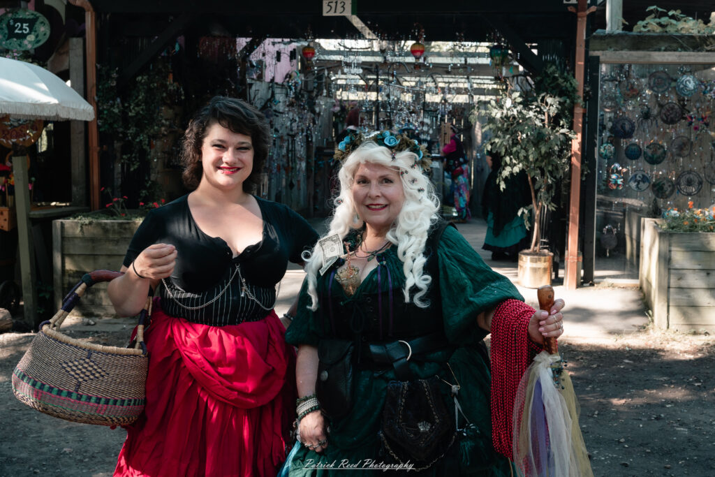 A costumed performer at the Michigan Renaissance Festival 2025, wearing traditional Renaissance attire during a live event in Holly, Michigan.
