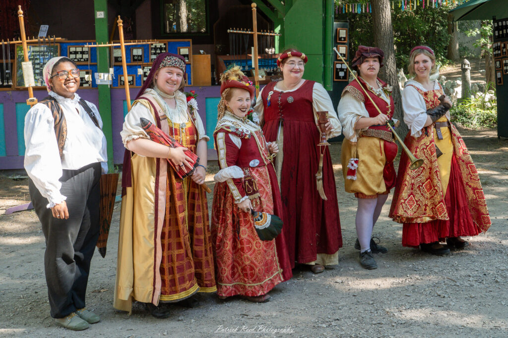 A costumed performer at the Michigan Renaissance Festival 2025, wearing traditional Renaissance attire during a live event in Holly, Michigan.
