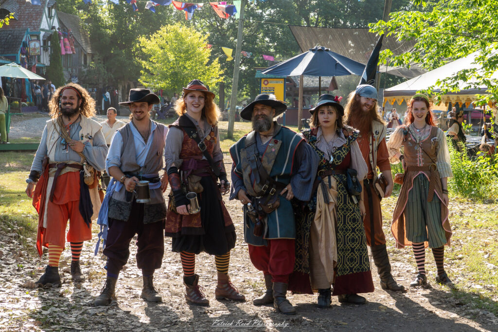 A costumed performer at the Michigan Renaissance Festival 2025, wearing traditional Renaissance attire during a live event in Holly, Michigan.