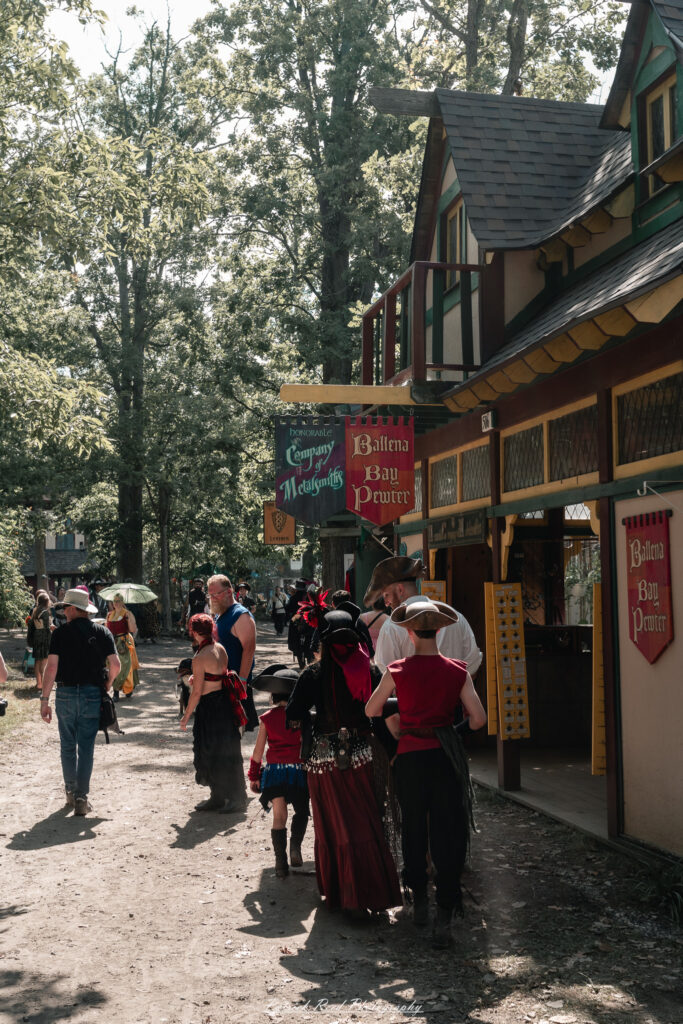A costumed performer at the Michigan Renaissance Festival 2025, wearing traditional Renaissance attire during a live event in Holly, Michigan.
