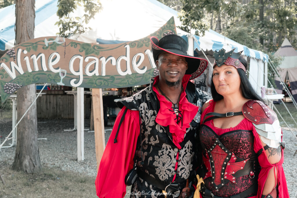 A costumed performer at the Michigan Renaissance Festival 2025, wearing traditional Renaissance attire during a live event in Holly, Michigan.