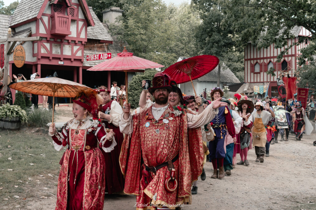 A costumed performer at the Michigan Renaissance Festival 2025, wearing traditional Renaissance attire during a live event in Holly, Michigan.