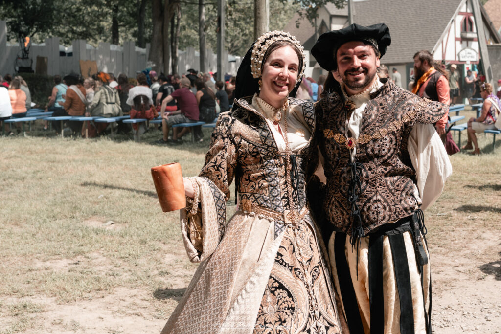 A costumed performer at the Michigan Renaissance Festival 2025, wearing traditional Renaissance attire during a live event in Holly, Michigan.