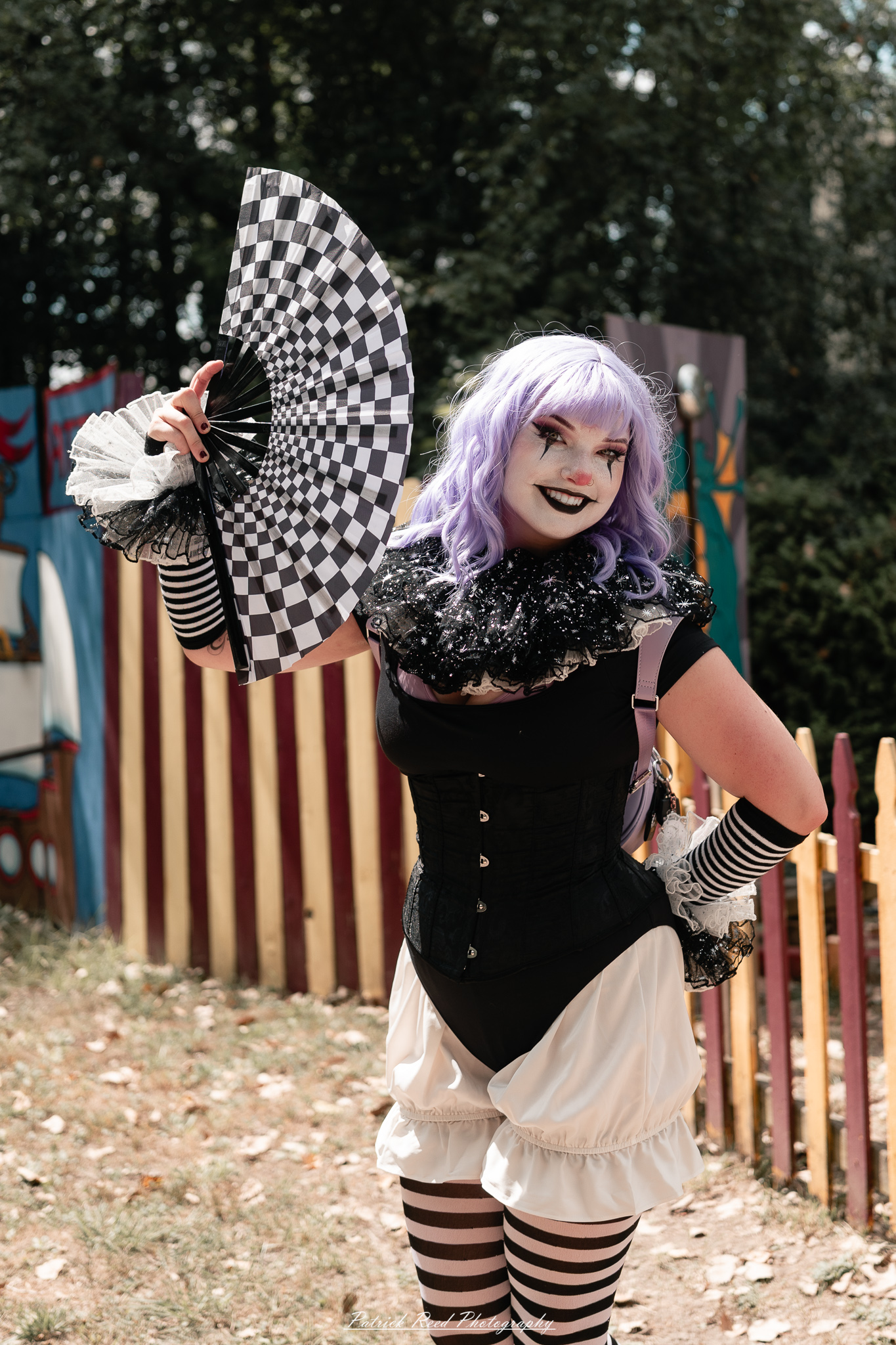 A costumed performer at the Michigan Renaissance Festival 2025, wearing traditional Renaissance attire during a live event in Holly, Michigan.