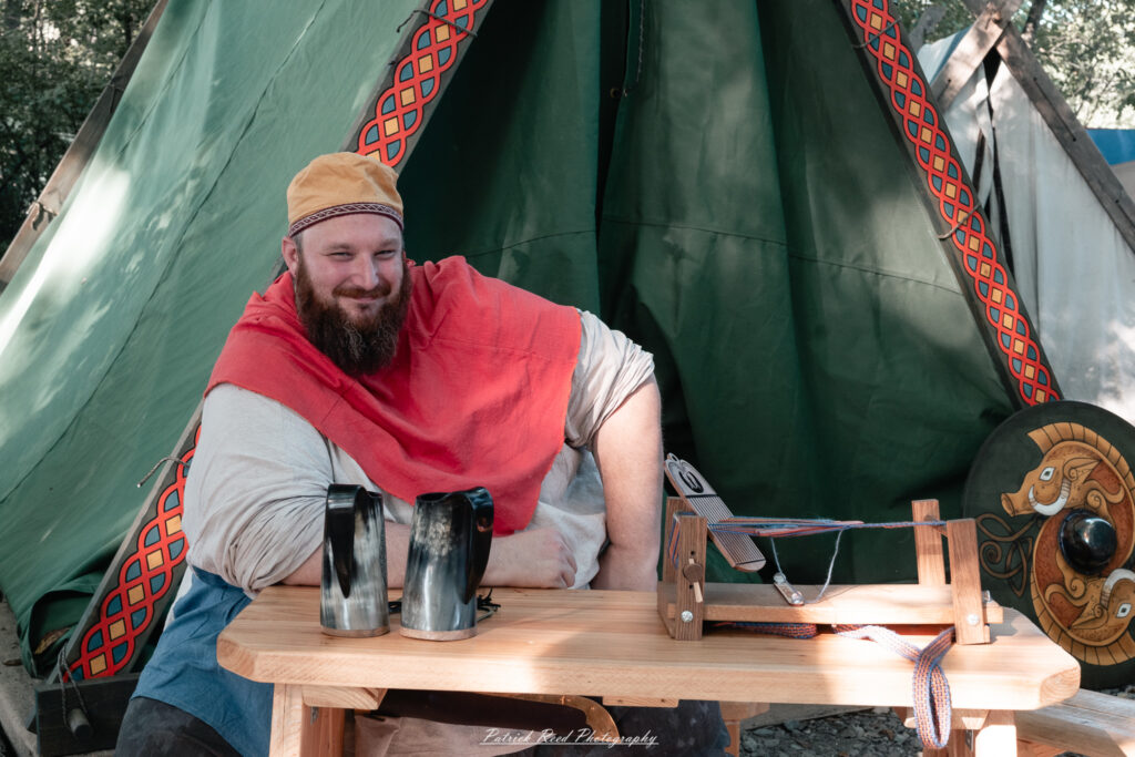 A costumed performer at the Michigan Renaissance Festival 2025, wearing traditional Renaissance attire during a live event in Holly, Michigan.