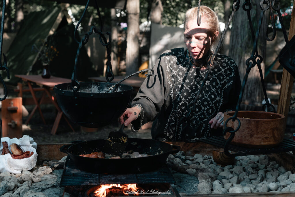 A costumed performer at the Michigan Renaissance Festival 2025, wearing traditional Renaissance attire during a live event in Holly, Michigan.