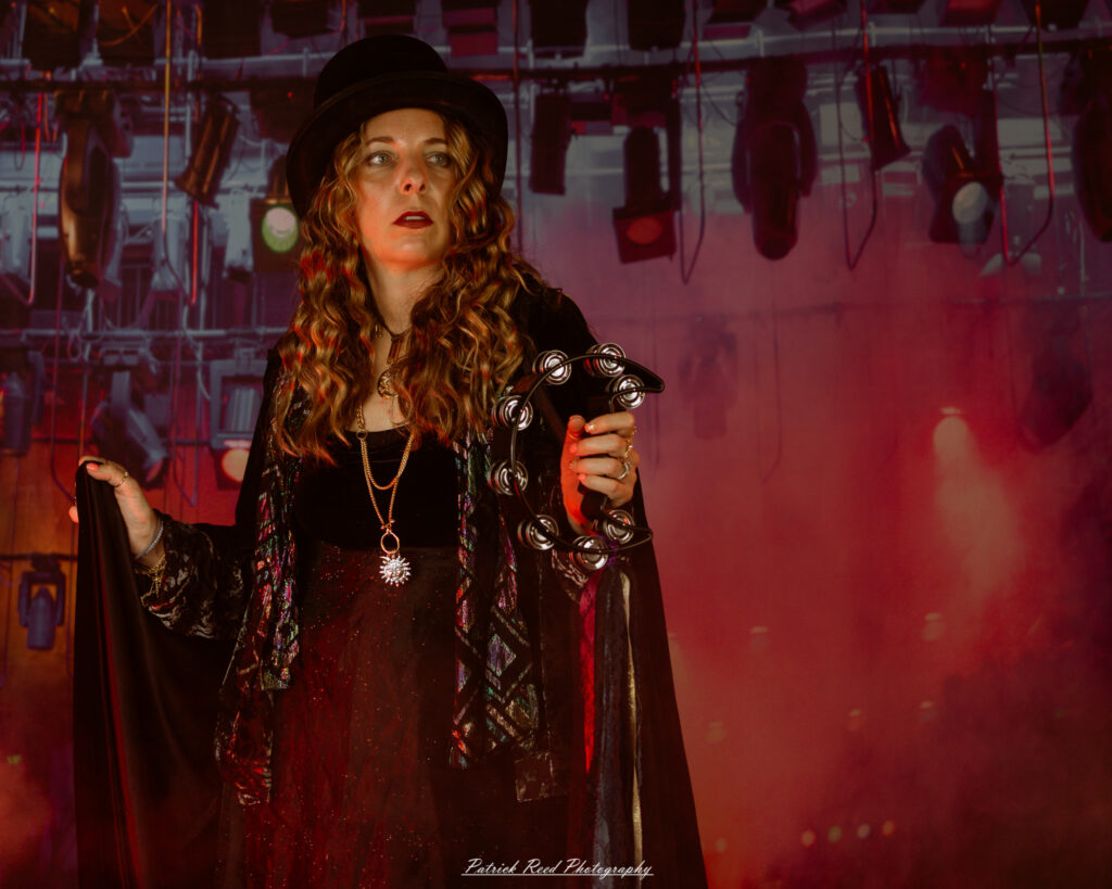 A woman dressed in flowing bohemian attire, channeling Stevie Nicks with layered fabrics, soft textures, and moody lighting.