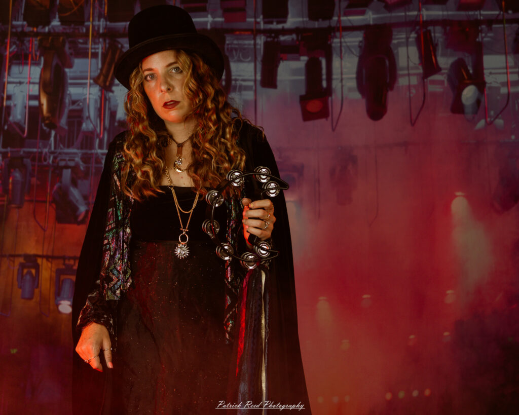 A woman dressed in flowing bohemian attire, channeling Stevie Nicks with layered fabrics, soft textures, and moody lighting.