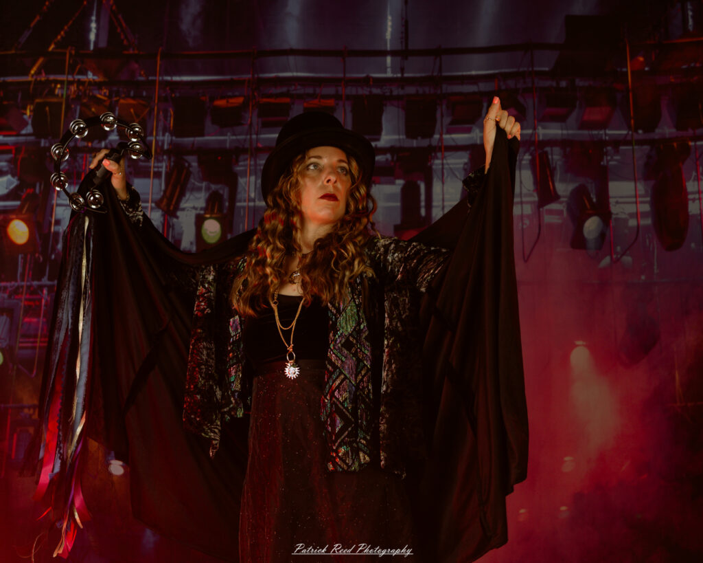 A woman dressed in flowing bohemian attire, channeling Stevie Nicks with layered fabrics, soft textures, and moody lighting.