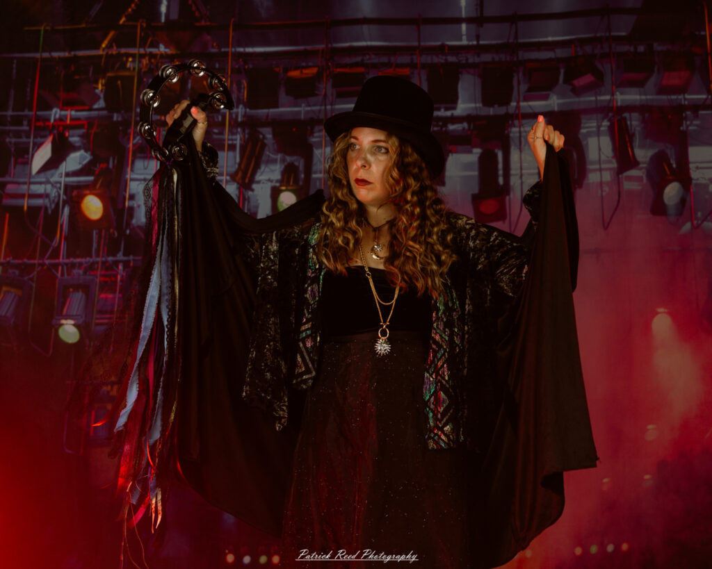 A woman dressed in flowing bohemian attire, channeling Stevie Nicks with layered fabrics, soft textures, and moody lighting.