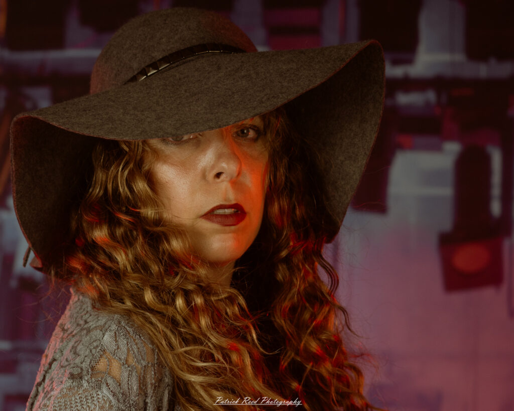 A woman dressed in flowing bohemian attire, channeling Stevie Nicks with layered fabrics, soft textures, and moody lighting.