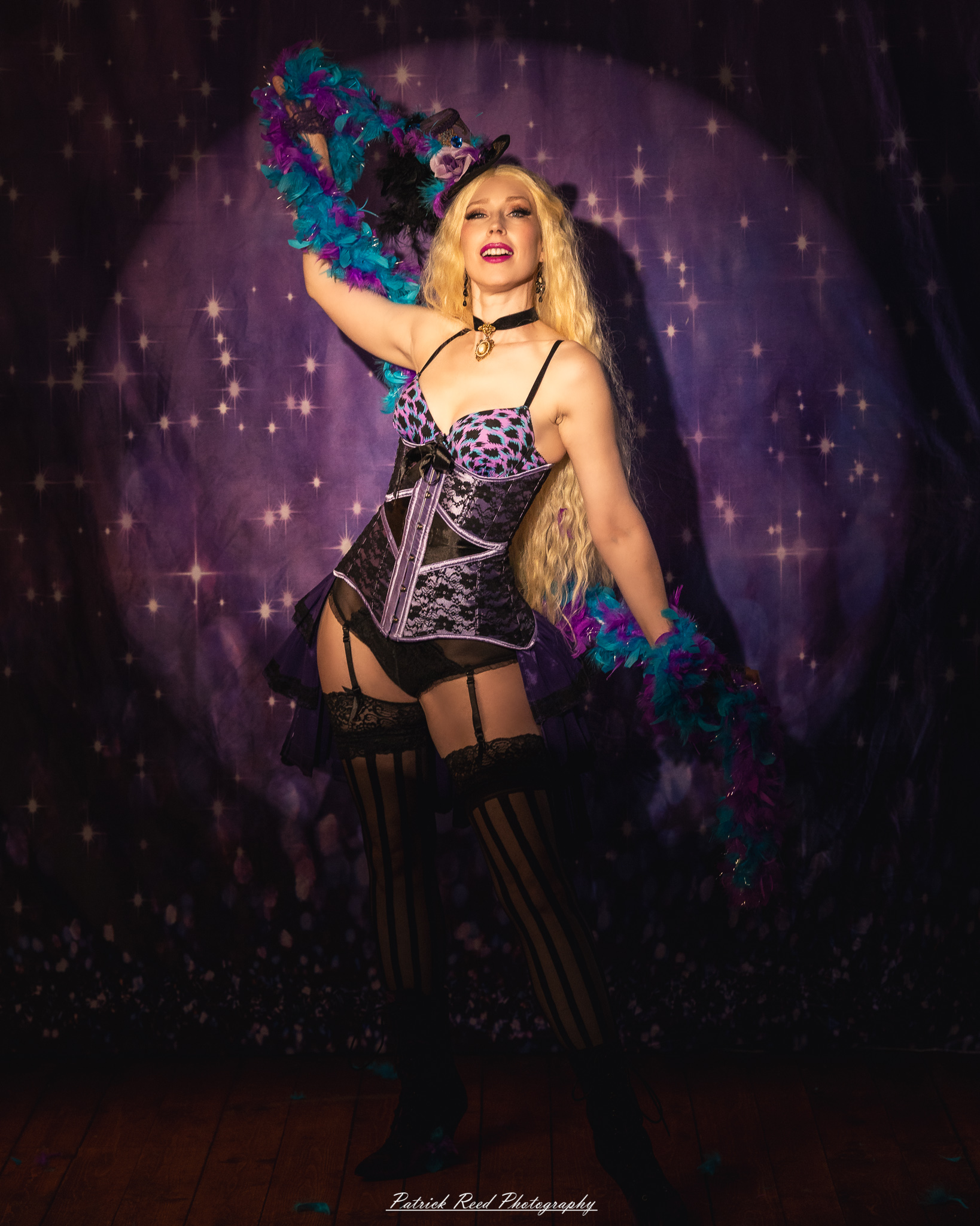 A cabaret-themed portrait featuring dramatic stage-inspired lighting, bold styling, and theatrical atmosphere. The image captures vintage glamour with a moody, performance-driven aesthetic.