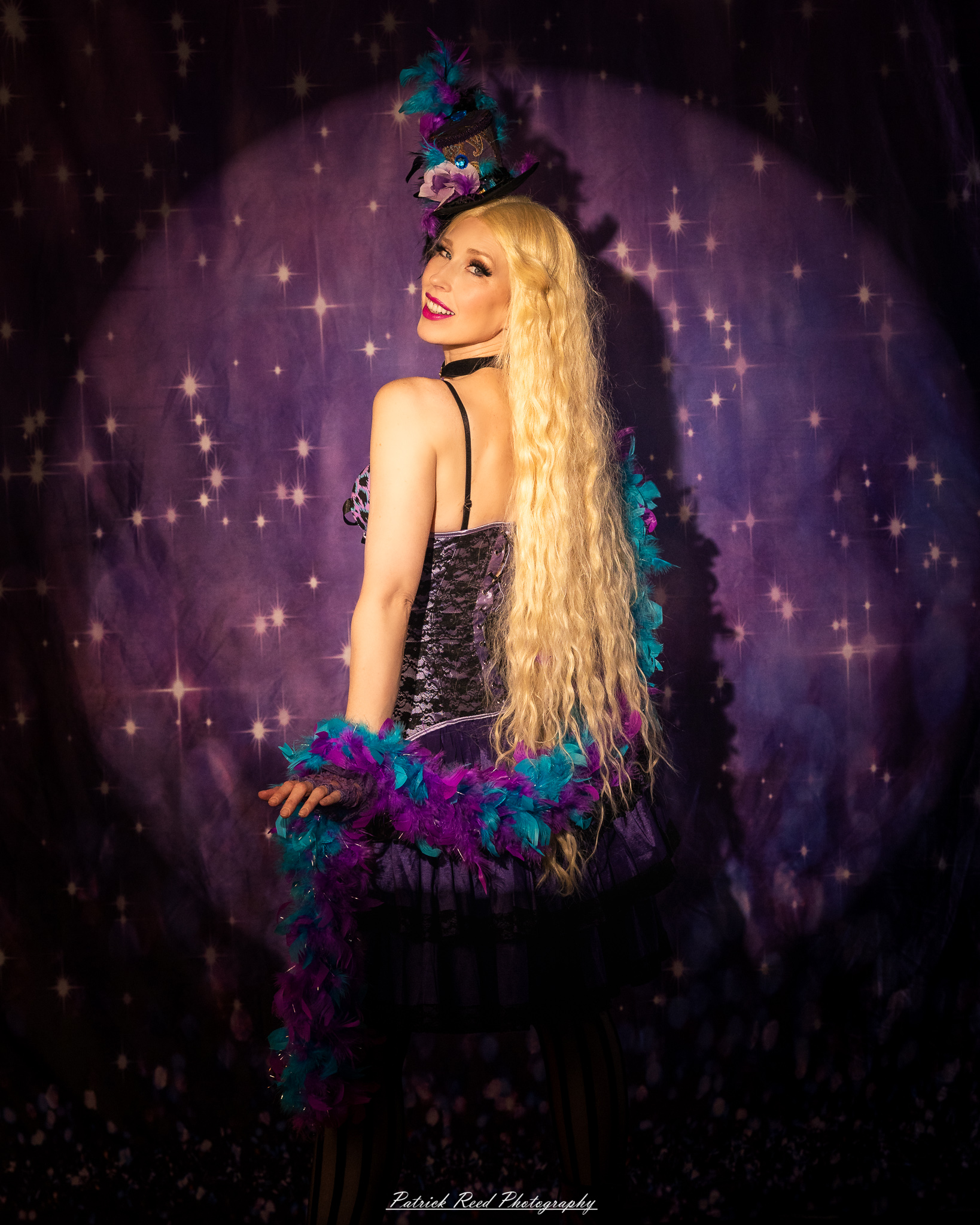 A cabaret-themed portrait featuring dramatic stage-inspired lighting, bold styling, and theatrical atmosphere. The image captures vintage glamour with a moody, performance-driven aesthetic.