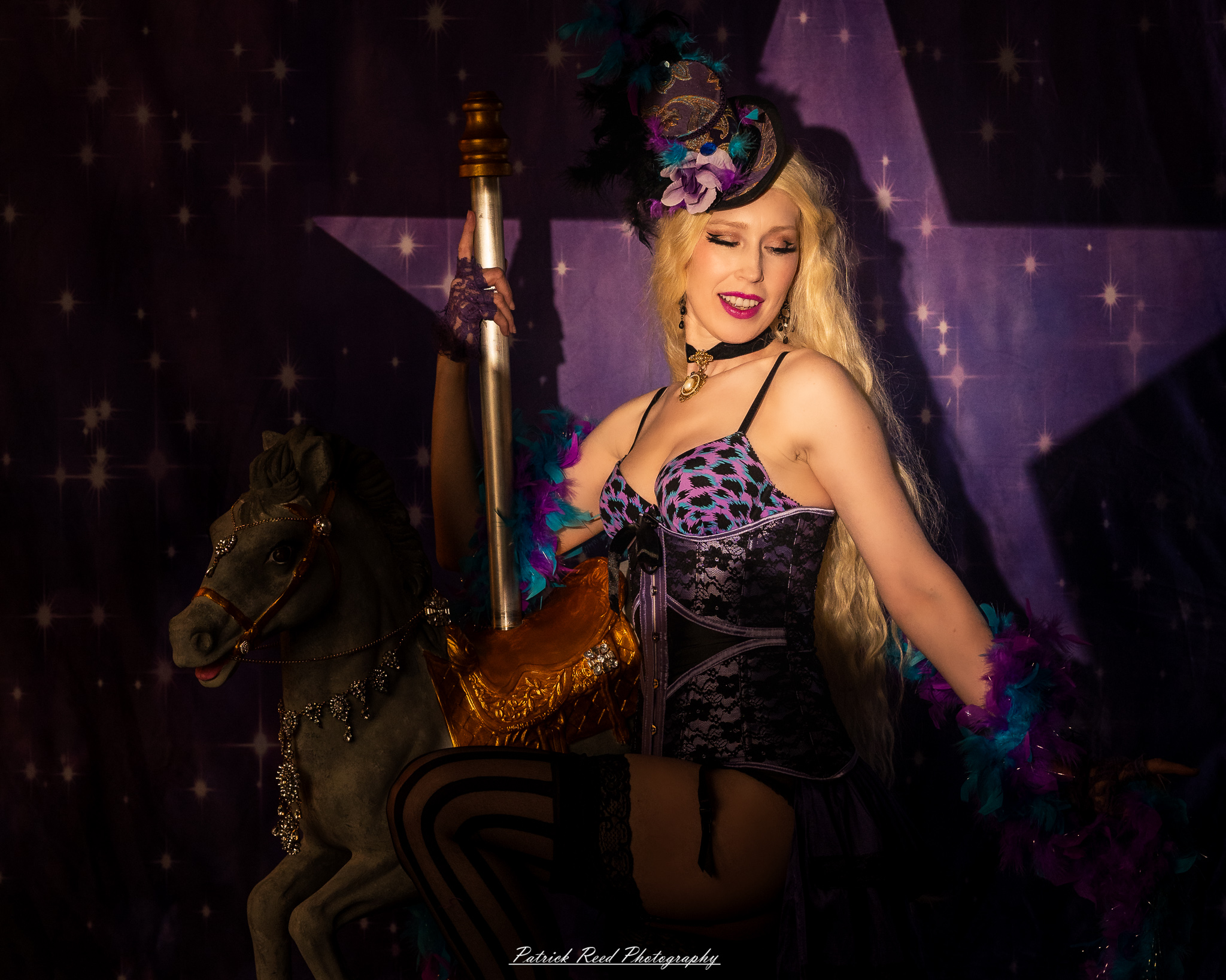 A cabaret-themed portrait featuring dramatic stage-inspired lighting, bold styling, and theatrical atmosphere. The image captures vintage glamour with a moody, performance-driven aesthetic.