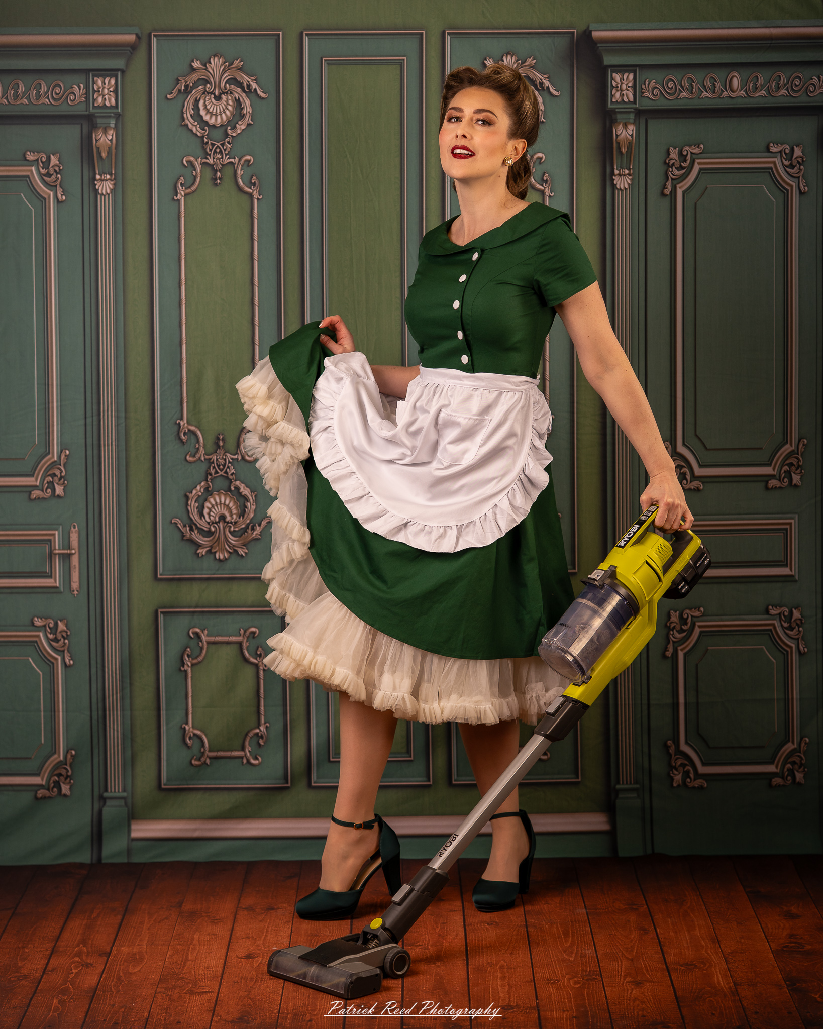 “Vintage-inspired portrait of a woman in a green 1950s dress holding a vacuum in a stylized retro room”