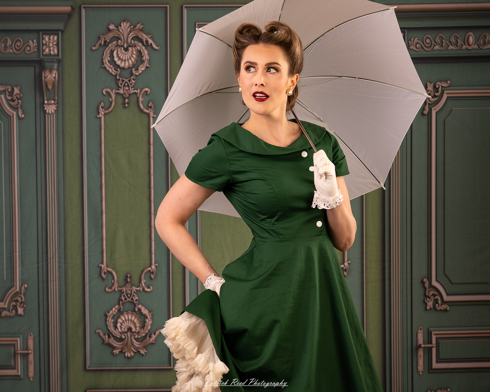 “Elegant vintage-style portrait of a woman holding a white umbrella in a studio setting”