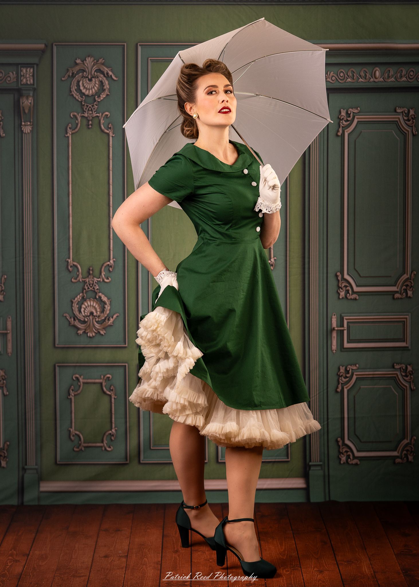“Elegant vintage-style portrait of a woman holding a white umbrella in a studio setting”