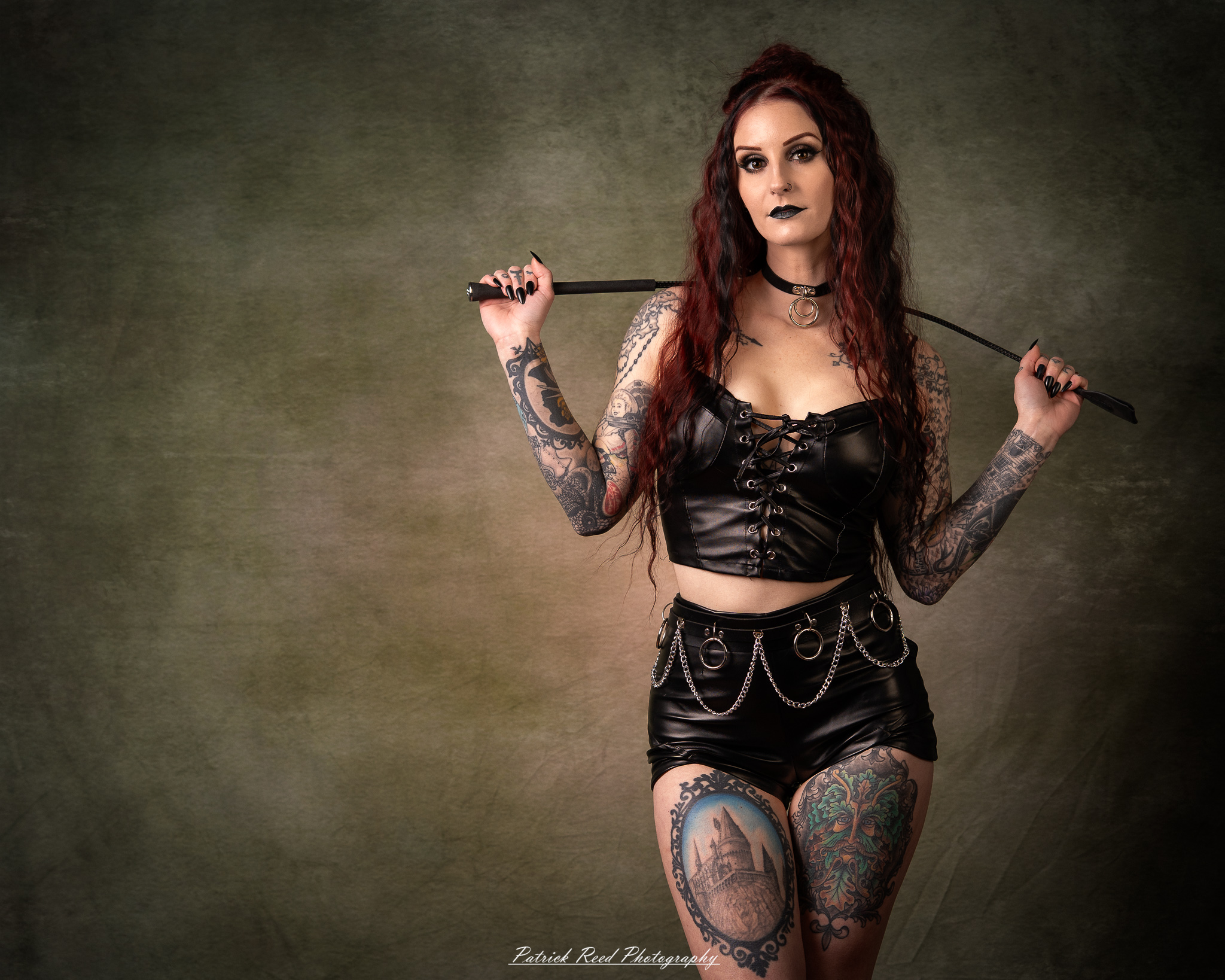 Portraits of a tattooed goth woman photographed on February 25, 2026. The images feature dark styling, visible body art, and moody, dramatic lighting.