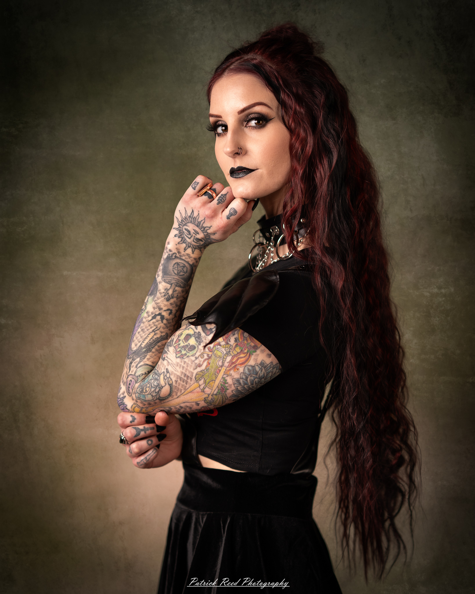 Portraits of a tattooed goth woman photographed on February 25, 2026. The images feature dark styling, visible body art, and moody, dramatic lighting.