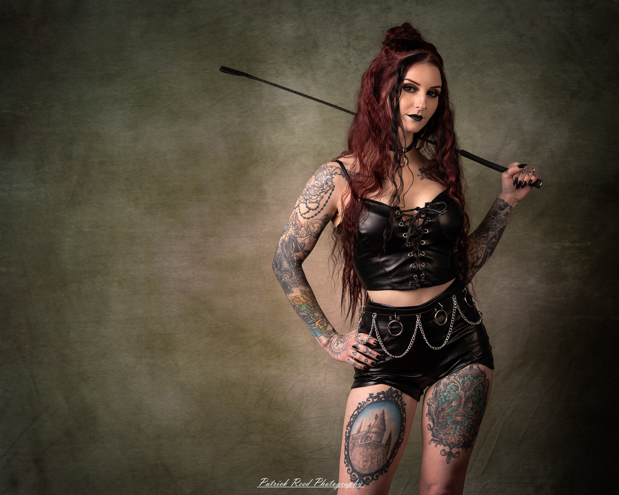 Portraits of a tattooed goth woman photographed on February 25, 2026. The images feature dark styling, visible body art, and moody, dramatic lighting.