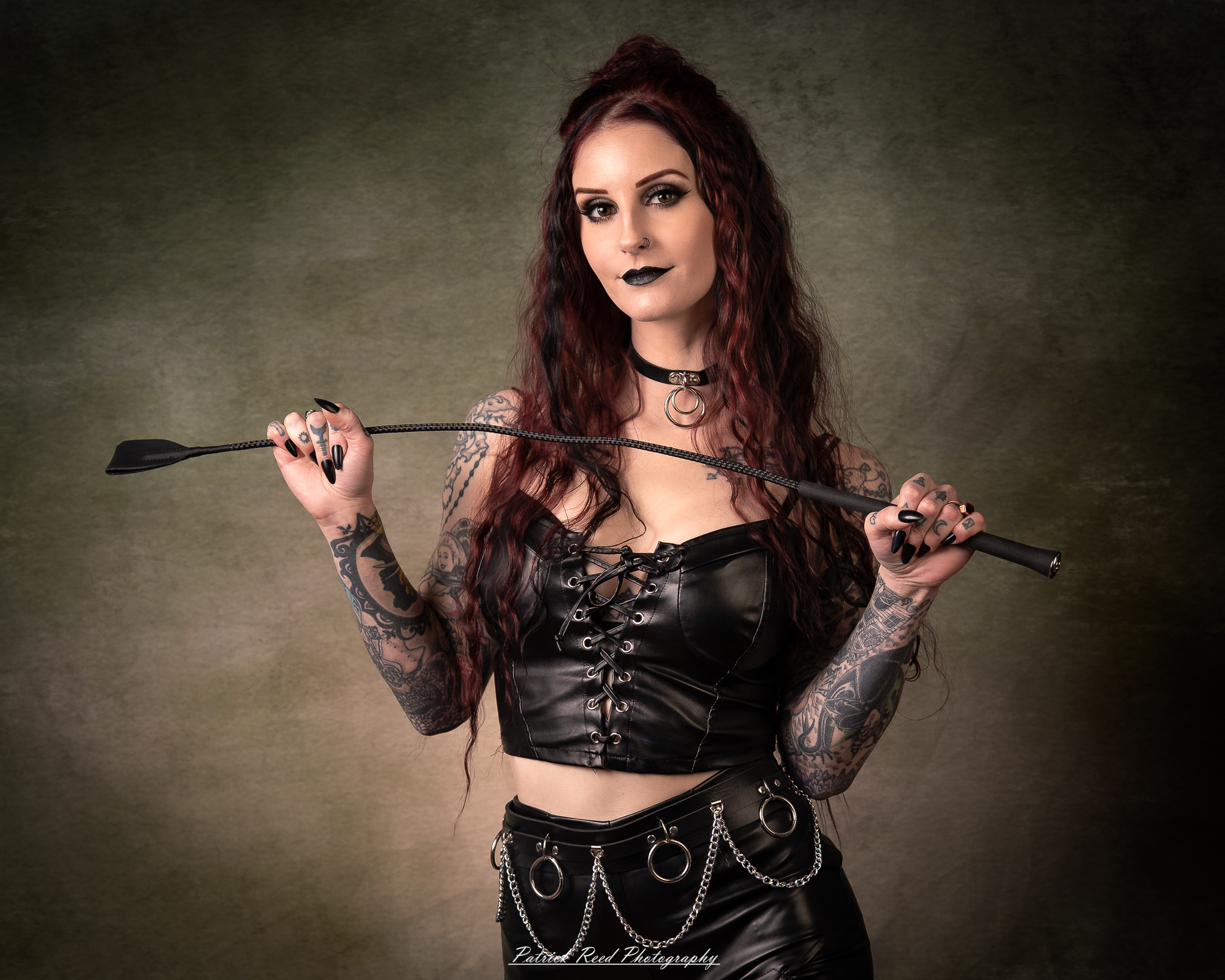 Portraits of a tattooed goth woman photographed on February 25, 2026. The images feature dark styling, visible body art, and moody, dramatic lighting.