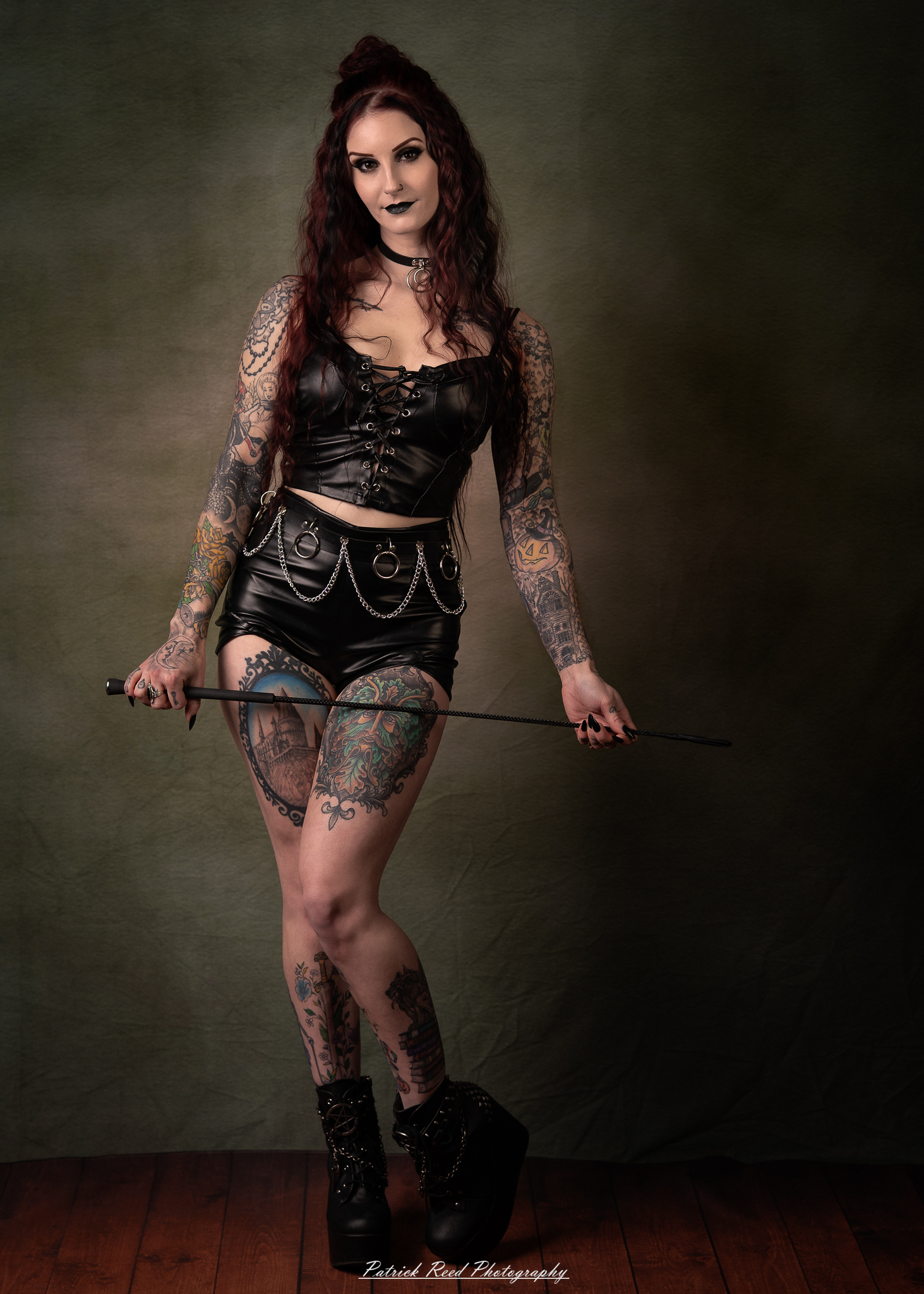 Portraits of a tattooed goth woman photographed on February 25, 2026. The images feature dark styling, visible body art, and moody, dramatic lighting.