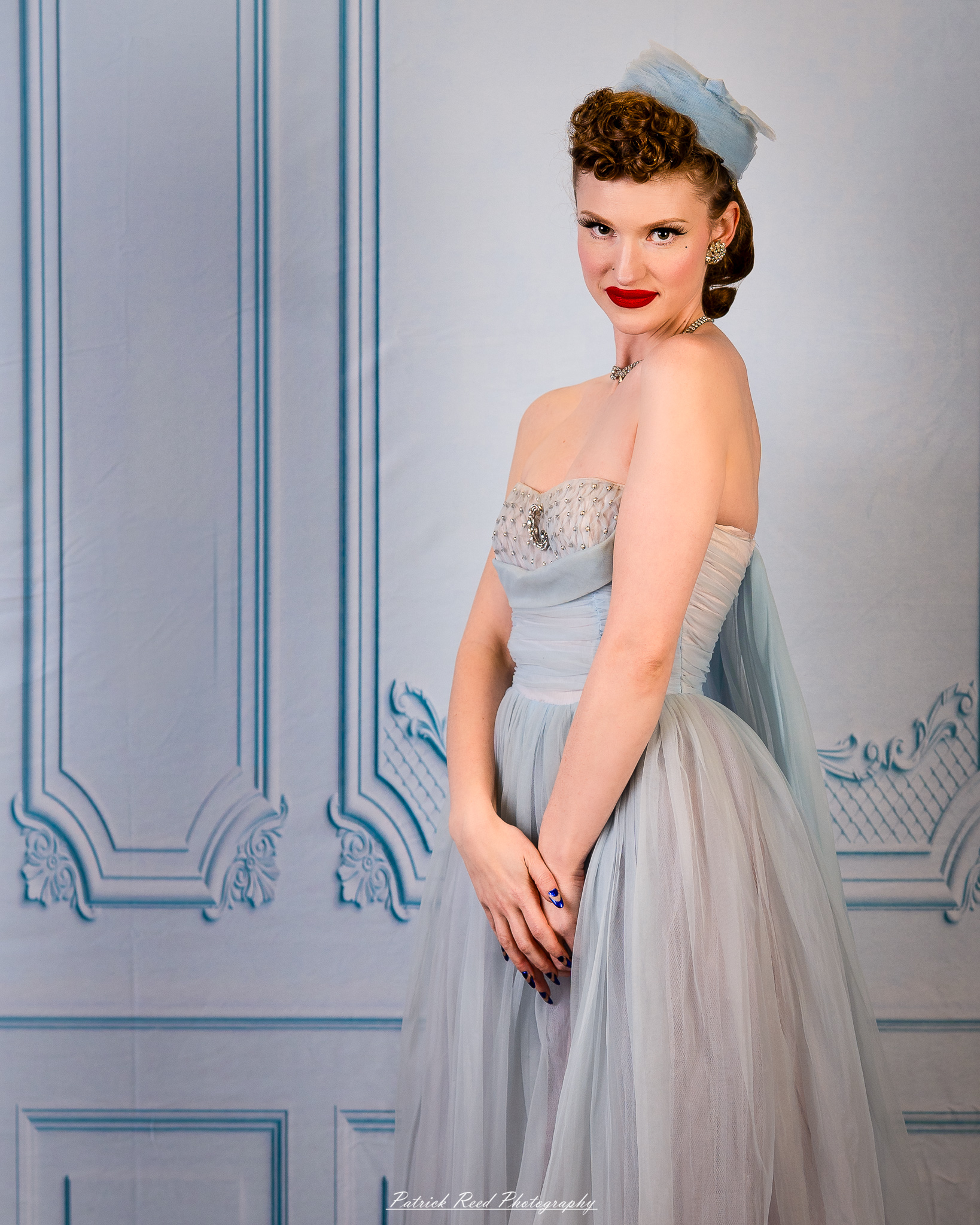 A retro-inspired portrait series of a model named Noelle photographed on March 13, 2026, featuring mid-century fashion styling, vintage hairstyles, colorful studio sets, and dramatic editorial lighting.