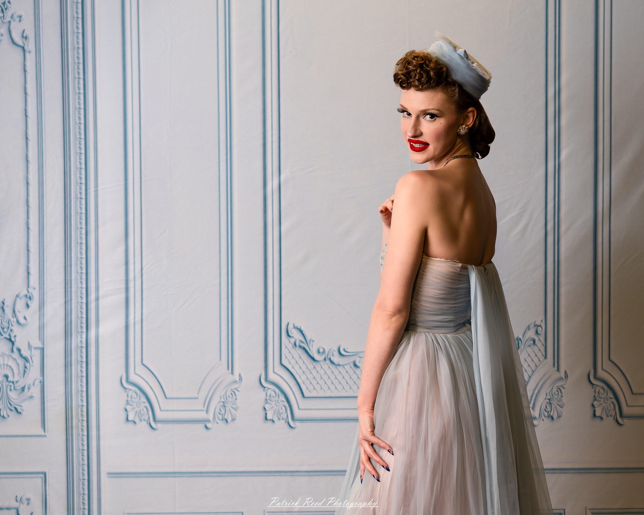 A retro-inspired portrait series of a model named Noelle photographed on March 13, 2026, featuring mid-century fashion styling, vintage hairstyles, colorful studio sets, and dramatic editorial lighting.