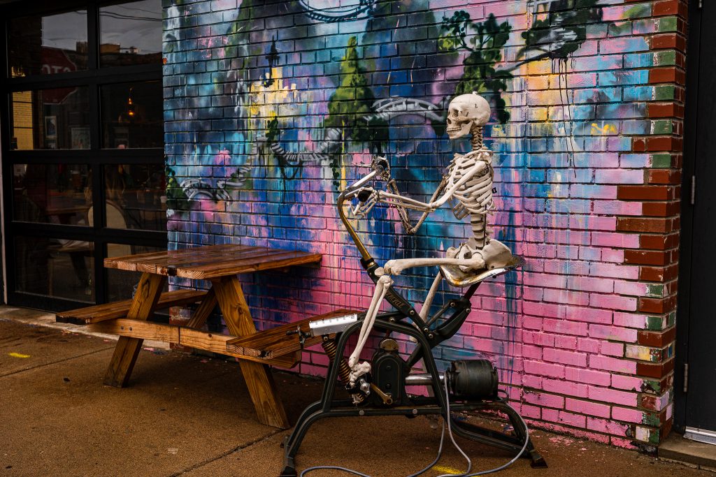 Large-scale mural in Eastern Market Detroit with layered graffiti textures and urban street art composition.