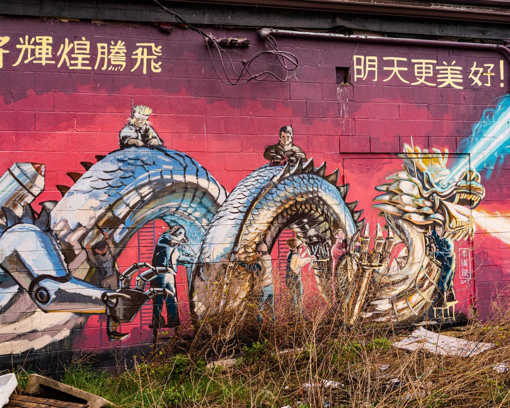 Large-scale mural in Eastern Market Detroit with layered graffiti textures and urban street art composition.