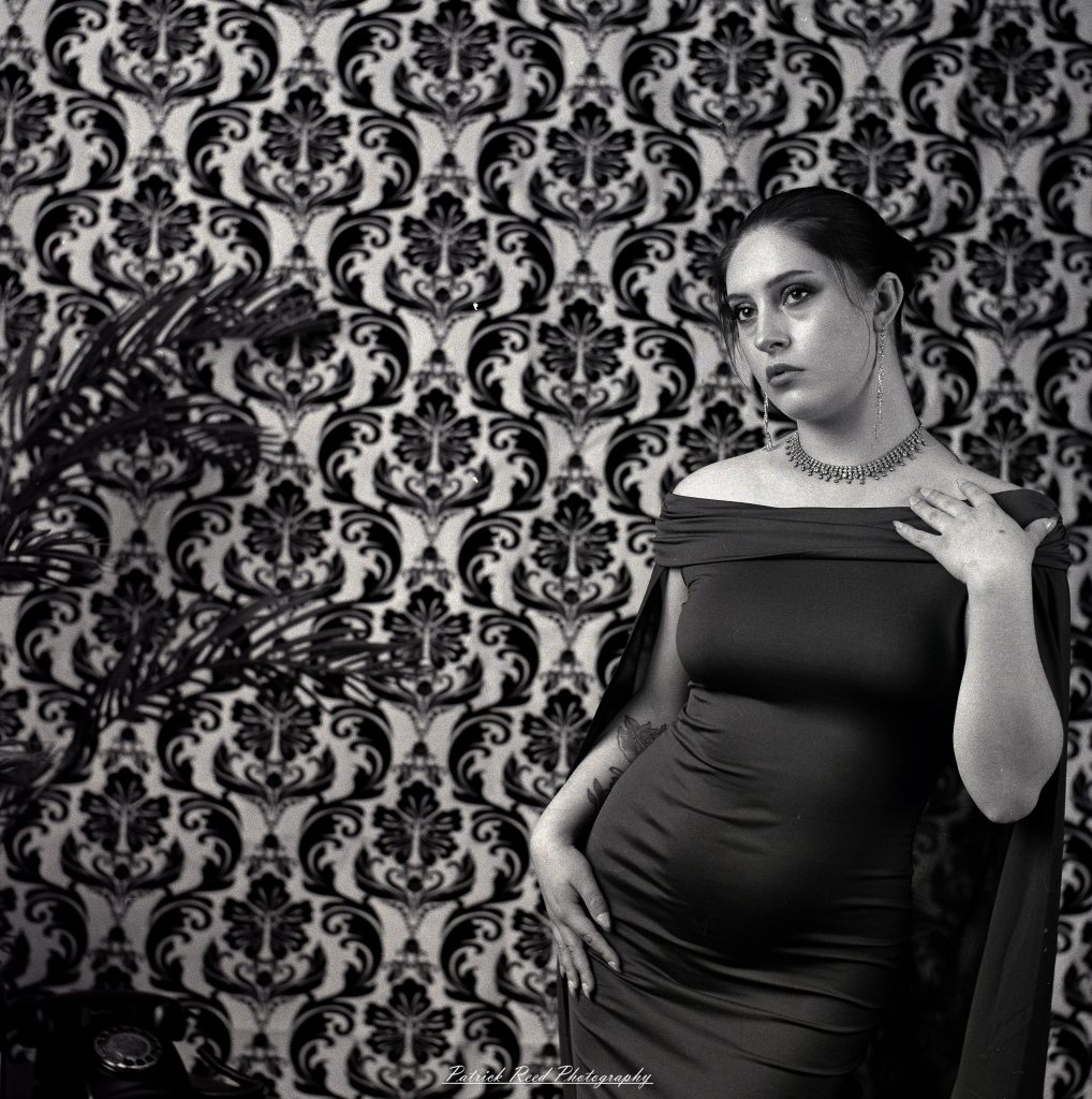 A vintage fashion portrait of Jinx, photographed on medium format film using a Mamiya C33. The session combines classic styling with the tonal depth and softness of analog photography, creating a timeless studio portrait inspired by mid-century fashion aesthetics.