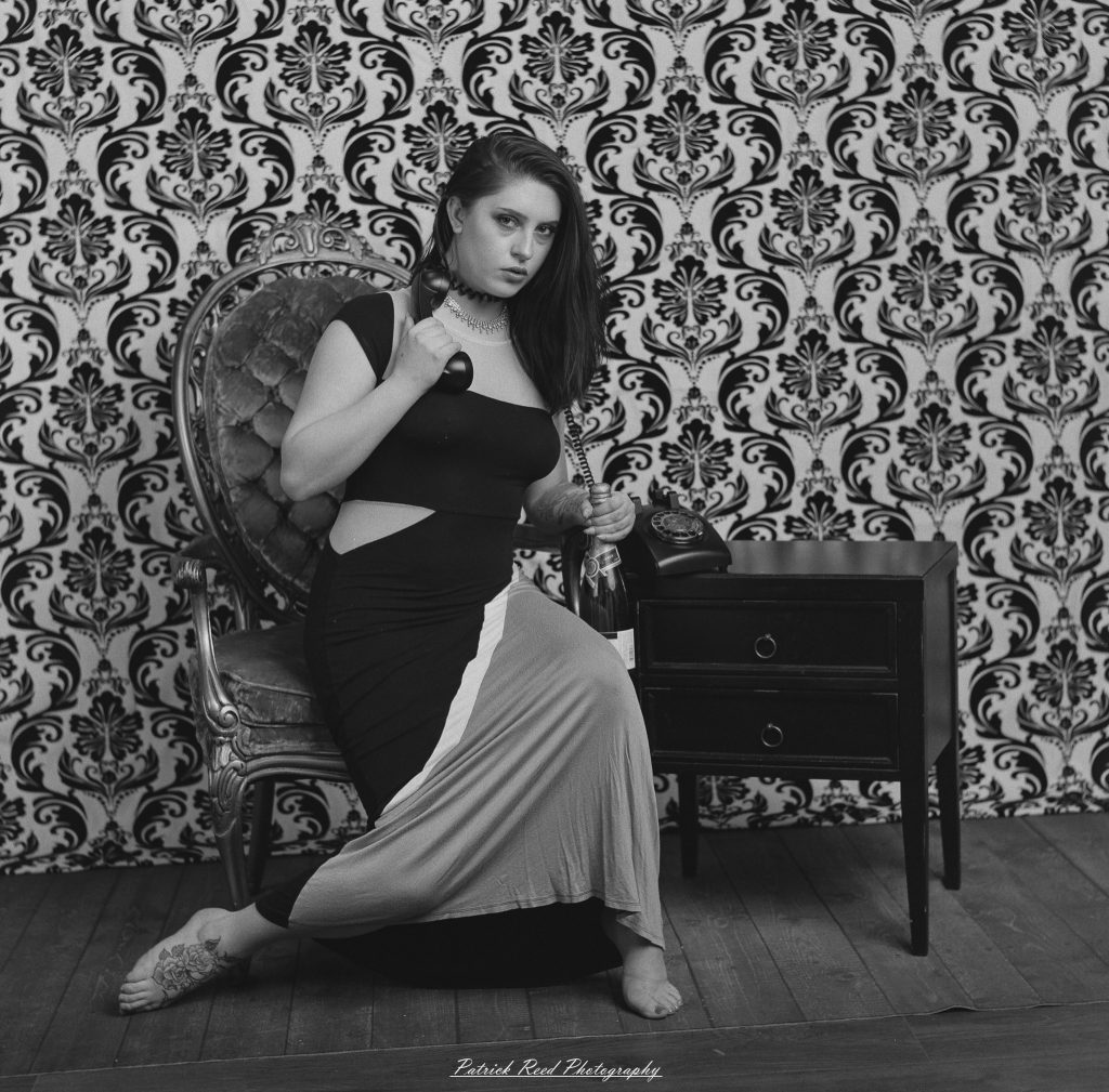 A vintage fashion portrait of Jinx, photographed on medium format film using a Mamiya C33. The session combines classic styling with the tonal depth and softness of analog photography, creating a timeless studio portrait inspired by mid-century fashion aesthetics.